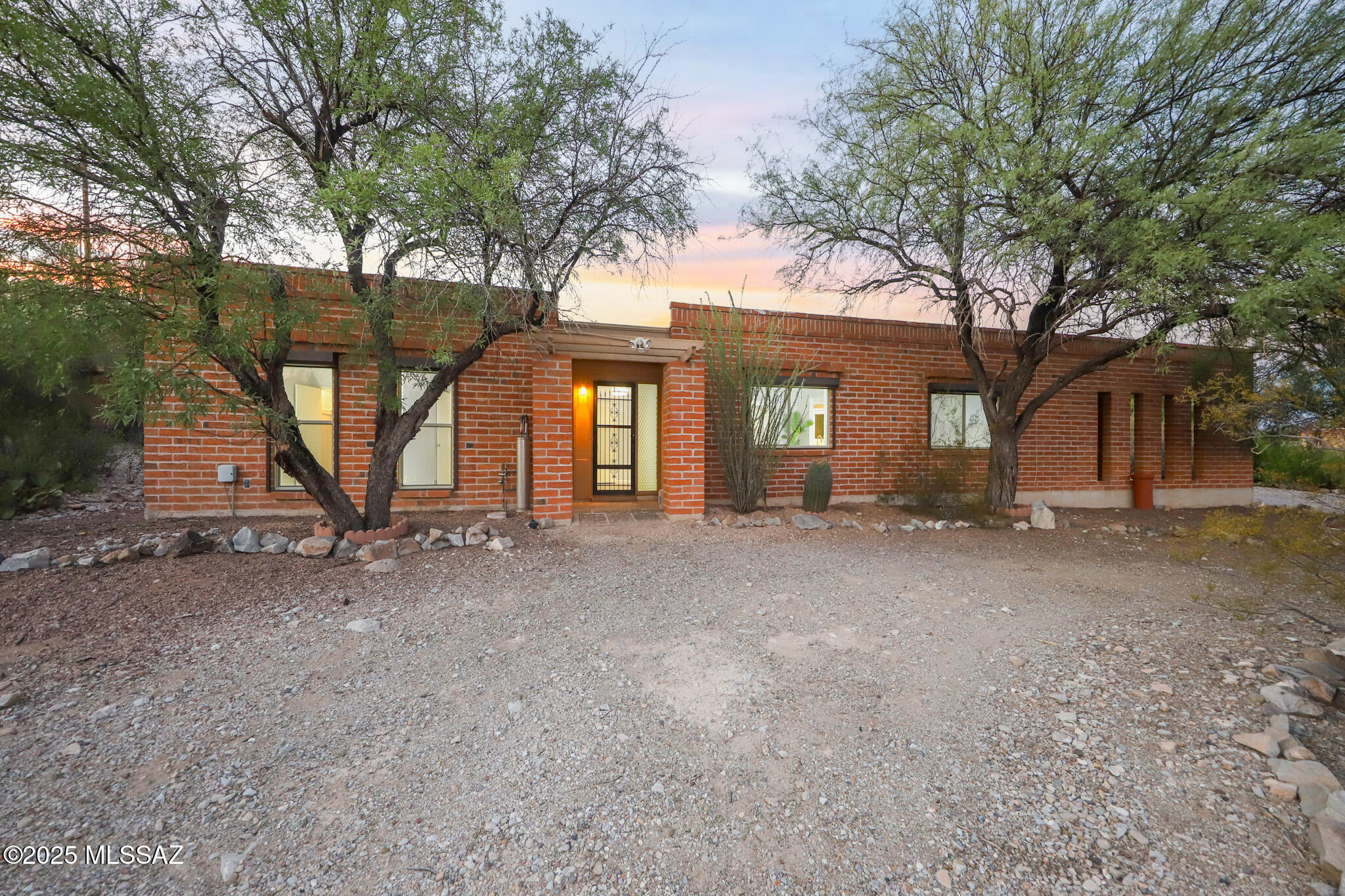Nestled on a 1.11-acre hilltop surrounded by Tucson's natural desert landscape, this stunning 3-bedroom, 2-bathroom home offers spacious living with an open floor plan. Relax by the fireplace and take in the scenic residential hilltop views while enjoying amazing Tucson sunsets.