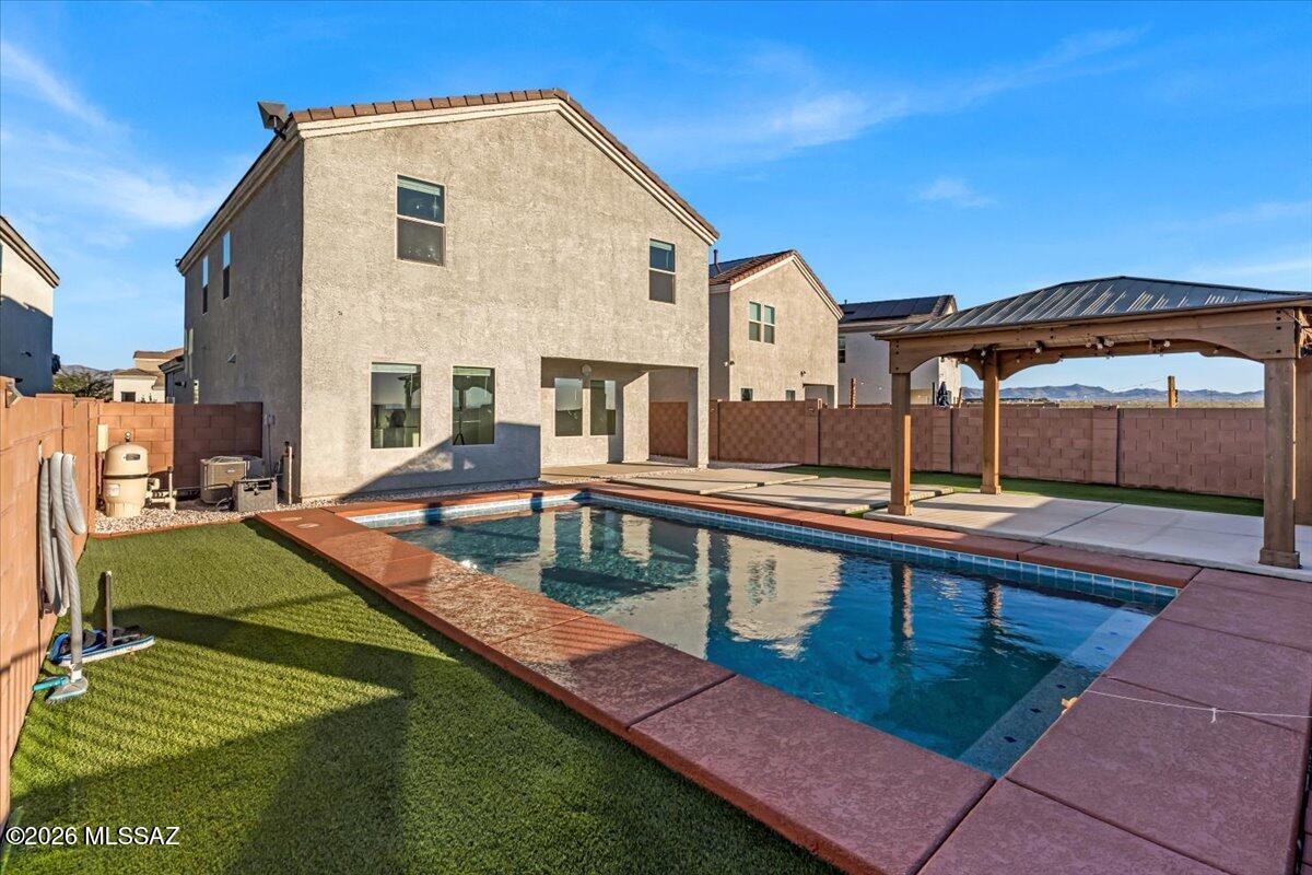 NEED HELP WITH CLOSING COSTS?

BACKYARD GOALS + SCENIC VIEWS! 

This stunning 4-bed, 3-bath modern home features a loft and pool--one of the few in the community! The low-maintenance backyard is built for Arizona living with turf landscaping and a built-in gazebo, perfect for relaxing or entertaining. Inside, enjoy upgrades like stainless steel appliances, epoxy garage floors, a water softener, EV hookup availability, Google thermostat and solar panels to help offset energy costs. Conveniently located minutes from shopping centers, Vail schools, and freeway access. A rare opportunity you won't want to miss. Come see it for yourself!