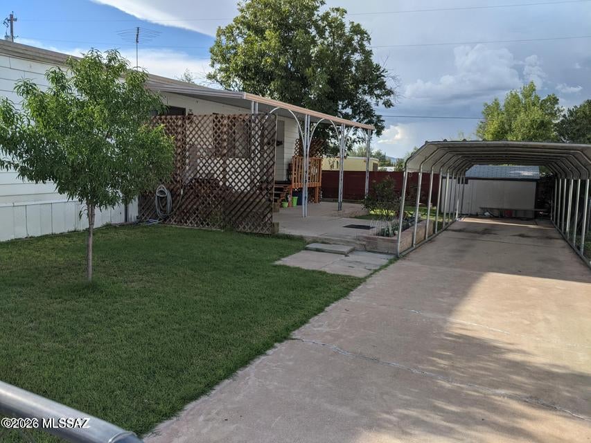 This 2 bedroom 2 bath manufactured home has been upgraded inside with sheetrock walls, laminate floors, new kitchen cabinet uppers and lowers.  Has a brand new heating and cooling HVAC unit. It has storm windows, 1 detached storage sheds, a large covered patio , covered parking, fenced yard with lovely grass and trees. Has above ground pool and hot tub.  Kitchen appliances purchased new in 2019, and water heater was new in 2018. Metal roof is approx 6 years old. Move in ready.