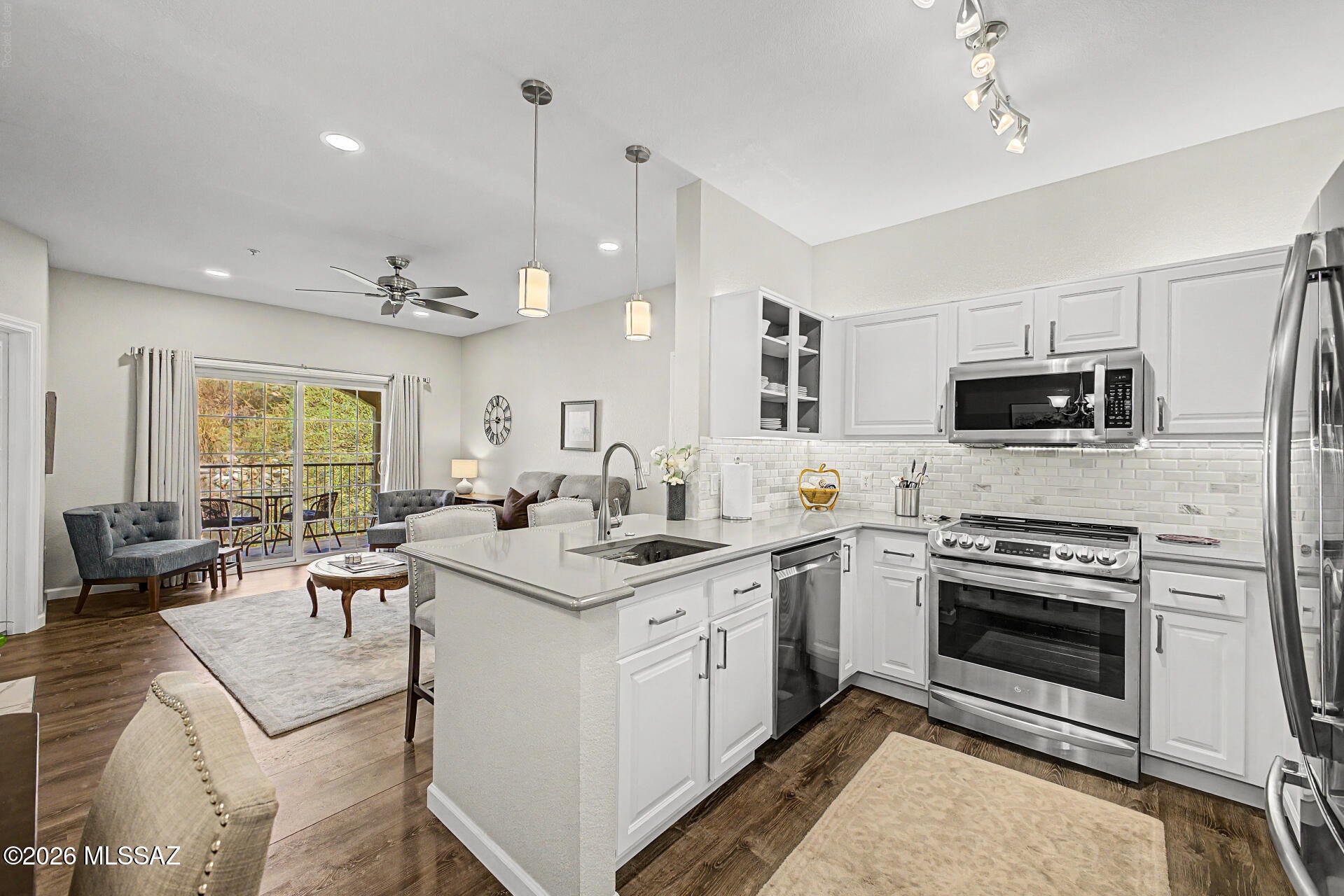 Beautifully remodeled upper-level condo in prestigious La Reserve - Move in ready AND Includes One Car Garage in Price! Fresh gray paint, modern laminate wood plank floors & upgraded tile wood-burning fireplace create an inviting, stylish living area. The Kitchen features crisp white cabinets, gray quartz countertops, a marble subway tile backsplash, open shelving & stainless steel appliances. Step onto your private upper balcony to take in peaceful desert & mountain views. Additional Updates include newer AC unit, all appliances, custom closet shelving & one-car garage AND additional covered parking space. HOA fee covers water, sewer, trash. Enjoy access to a sparkling pool, spa, clubhouse with kitchen & TV area, exercise rooms, game room-walkable to stores, restaurants, & walking paths!