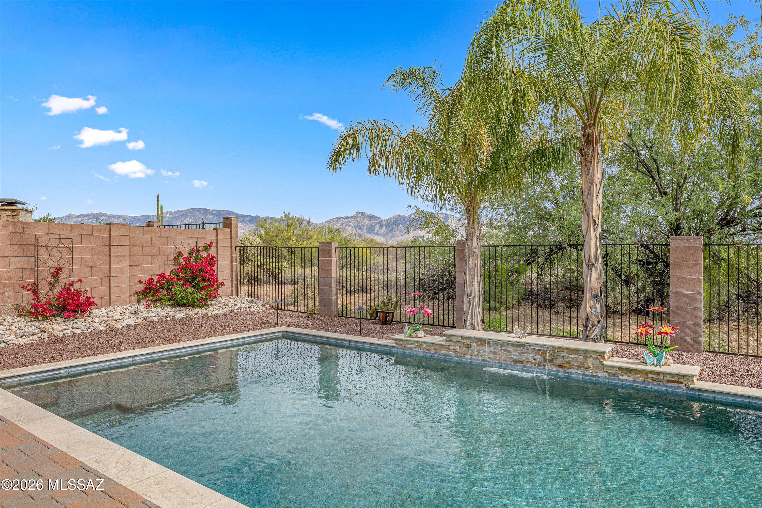 Rare 3,664 sqft, 6bd/5ba former model home, with 4-car tandem garage on a premium lot. Resort-style backyard with Catalina Mountain views. Main level includes 2bd/2 full baths: Upstairs loft and den serve as flex space. Remodeled kitchen with granite countertops, stainless steel appliances, and opens to the main living areas.
Oversized primary suite features a remodeled bathroom with soaking tub and private balcony with mountain views. The backyard is designed for entertaining, with a custom-built pebble
sheen pool, travertine decking, water feature, and built-in BBQ. Stacked
stone accents on all pillars add a custom touch, and mature fruit
trees include three varieties of orange, Lisbon lemon, and limequat. Look no further, this is your home.