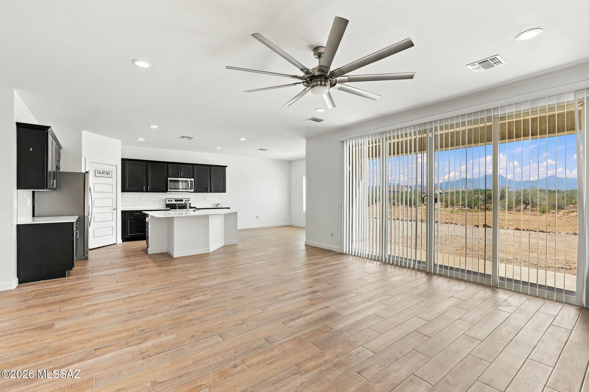 Welcome to 2930 E Yaney Ln in Sahuarita Acres! This 4-bedroom, 2-bath single-story home offers 2,094 sq ft on approximately 0.93 acres with a 3-car garage and beautiful mountain views. The open-concept great room flows into a spacious kitchen with a large island, walk-in pantry, stainless-steel appliances, and abundant cabinetry. A standout feature is the approximately 12-foot-wide sliding glass door, opening directly to the covered patio and mountain views--perfect for morning coffee, sunsets, or entertaining. The spacious lot offers a blank canvas for your own Arizona outdoor retreat. Includes refrigerator, washer, dryer, range, ceiling fans, blinds, and ADT alarm system convey.