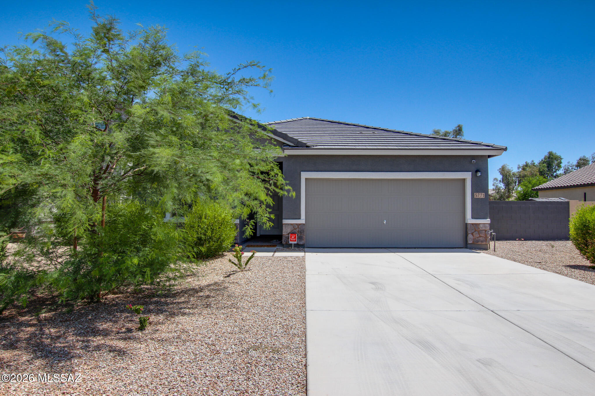 Immaculate 2023 Starlight Homes build in MagicRanch! This beautifully maintained home offers 4 bedrooms, 3 baths, of modern living. The open floor plan connects the kitchen, dining, and great room--perfect for entertaining or relaxing. The kitchens granite countertops, stainless steel appliances, a breakfast bar, and ample cabinetry. Tile flooring runs throughout the main living areas, complemented by custom built ins for added storage and style. The spacious primary suite includes a walkin closet and upgraded bath finishes. Step outside to a landscaped backyard with a covered patio ideal for enjoying Arizona's sunrise and starry nights. Backing to a natural wash, you'll appreciate privacy with no rear neighbors. Energy efficient construction and solar panels help reduce utility costs. Located near Anthem Elementary, this home blends convenience, quality, and pride of ownership in a peaceful community setting.