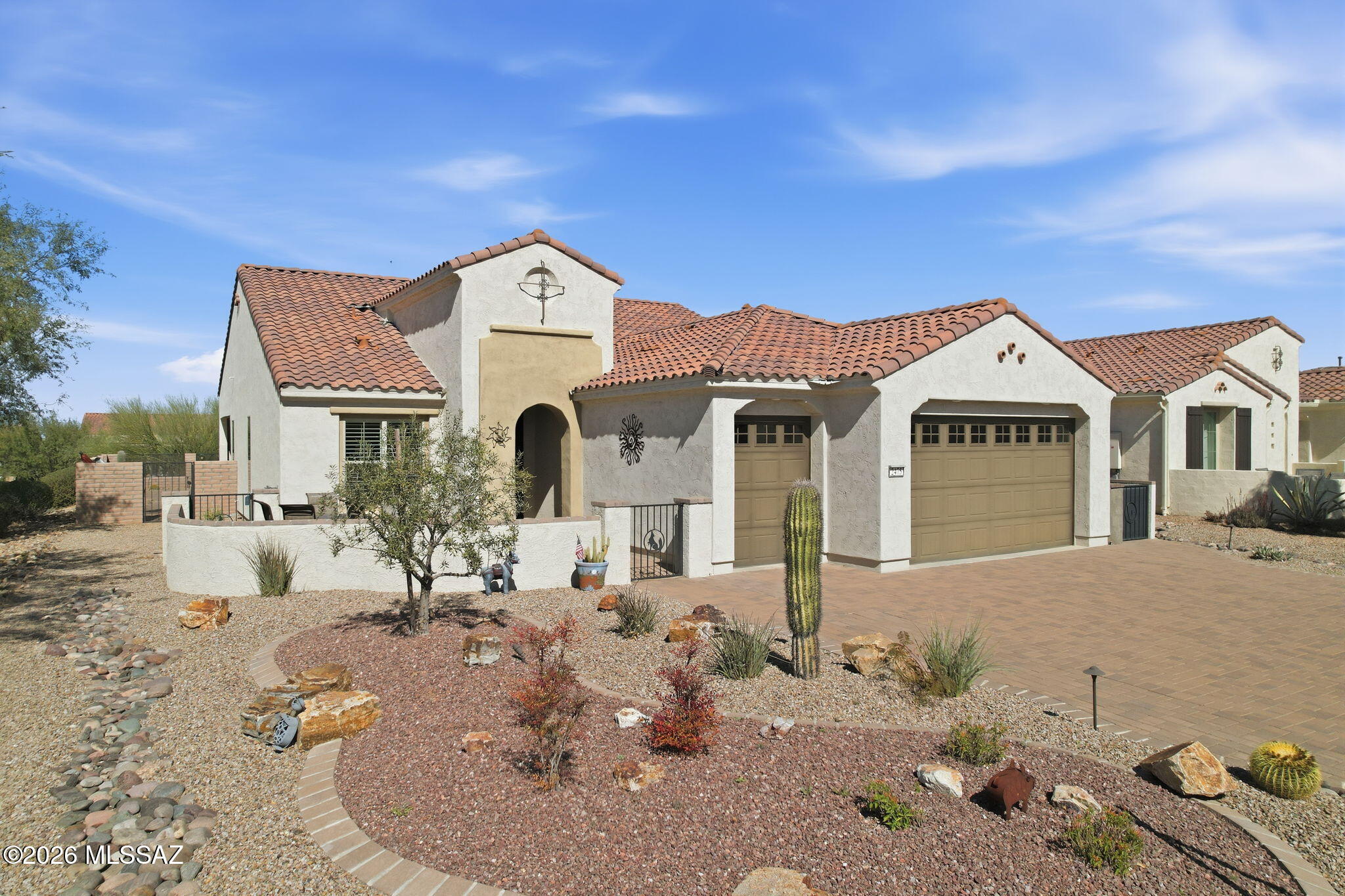 Price Improvement on this exceptional Quail Creek home. Built in 2020 and set on one of the community's larger lots, this property offers the resort lifestyle buyers come to Quail Creek for, with mountain views, refined finishes, and a backyard designed to enjoy Arizona living year round. Start the day on the welcoming front patio, then relax out back beside the sparkling pool, surrounded by desert landscaping, always green turf, and a built in gas BBQ. A view through wrought iron fence overlooks the natural desert arroyo, creating a private and peaceful setting that is hard to match.

Inside, the home strikes the right balance between comfort and style with tile in the main living areas, plush carpet in the bedrooms, custom ceiling fans, and upgraded lighting throughout. The gourmet kitchen is built for both daily living and entertaining, featuring a convection oven, butler's pantry, and beverage station with wet bar. A flexible bonus room nearby makes an ideal office, den, or hobby space.

The primary suite feels like a retreat, complete with a large tiled walk in shower with seating, dual vanities, and a spacious walk in closet. Guests enjoy their own ensuite bath, while an additional powder room adds convenience. The laundry room includes upper cabinetry along with a large Samsung washer and dryer.

Additional features include a custom security door, soft water system, attractive southwest exterior details, and an extended 2.5 car over height garage with room for a golf cart and extra storage.

Beyond the home itself, Quail Creek offers the lifestyle so many buyers are looking for, including golf, pickleball, tennis, fitness center, pools, bocce, clubs, and dining. With newer construction, upgraded finishes, and no wait to build, this move in ready home is an outstanding opportunity to enjoy one of Southern Arizona's premier active adult communities.