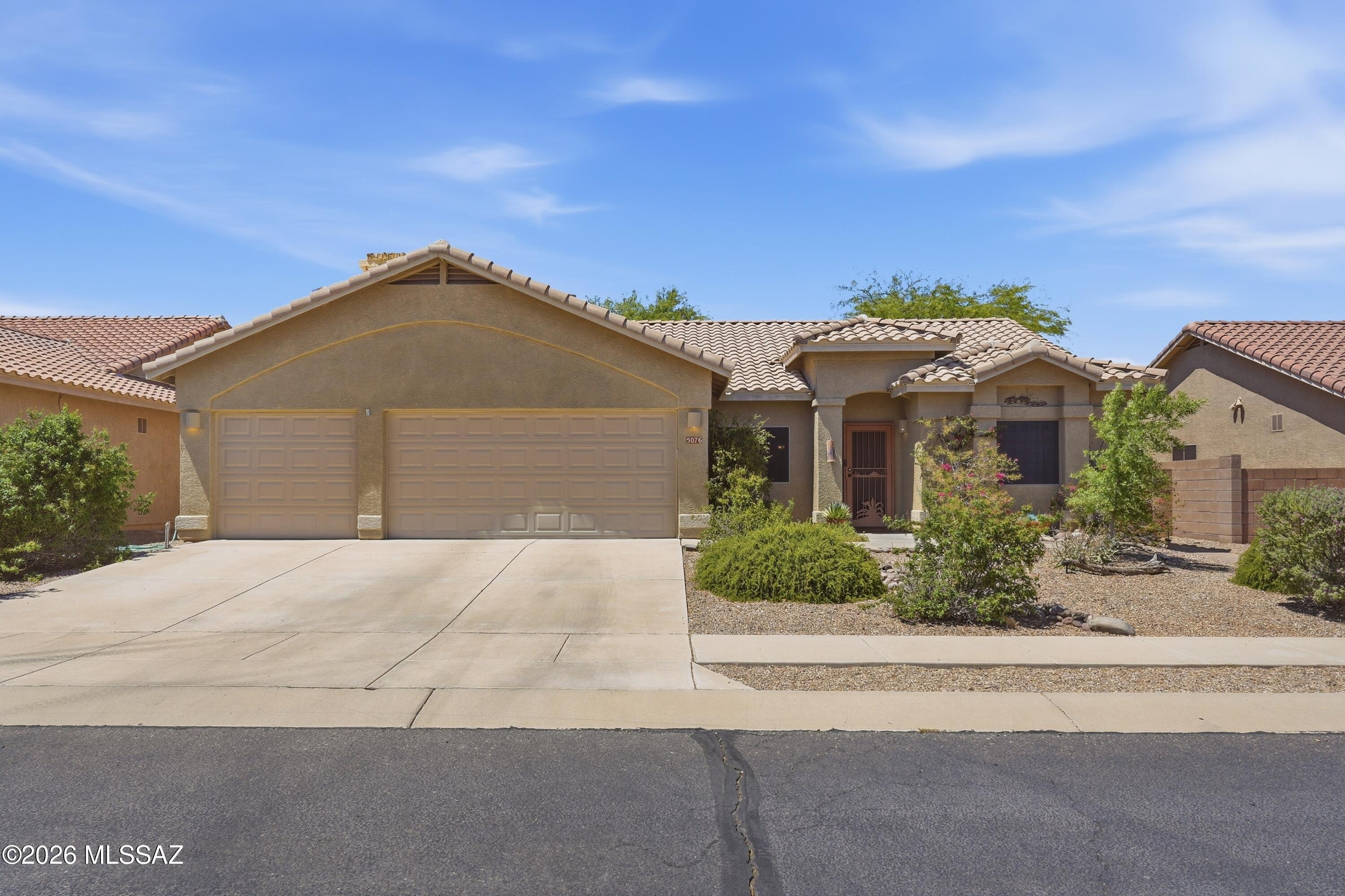 New roof! Immerse yourself in resort lifestyle with this beautiful, move-in-ready residence nestled inside the globally recognized Dove Mountain master-planned community. This 4BD/2BA (2,198sqft) home blends high-end comfort with spectacular functionality. The smart, split-bedroom floor plan centers around a gorgeous gourmet kitchen. Perfect for preparing daily meals or hosting weekend social hours, the kitchen features premium stainless-steel appliances, opening directly to a massive living area. The residence offers four spacious bedrooms, highlighted by a private primary suite that serves as a quiet escape. This sanctuary is uniquely equipped with dual matching walk-in closets and its own private entry leading out to the rear patio. The indoor-outdoor flow transitions effortlessly on to an extended covered back patio with ample space for dining, relaxing, and taking in big-sky Arizona sunsets. The low-maintenance, fully enclosed block-wall backyard features mature shade trees and serves as a private, intimate setting. Vehicle enthusiasts and hobbyists will love the extra-long, attached 3-car garage that provides immense storage space. Living in this enclave places world-class outdoor recreation directly at your doorstep. You are only minutes from the Wild Burro Trailhead with miles of hiking and biking trails, championship golf courses, elite tennis facilities, and the legendary spa amenities at The Ritz-Carlton, Dove Mountain.