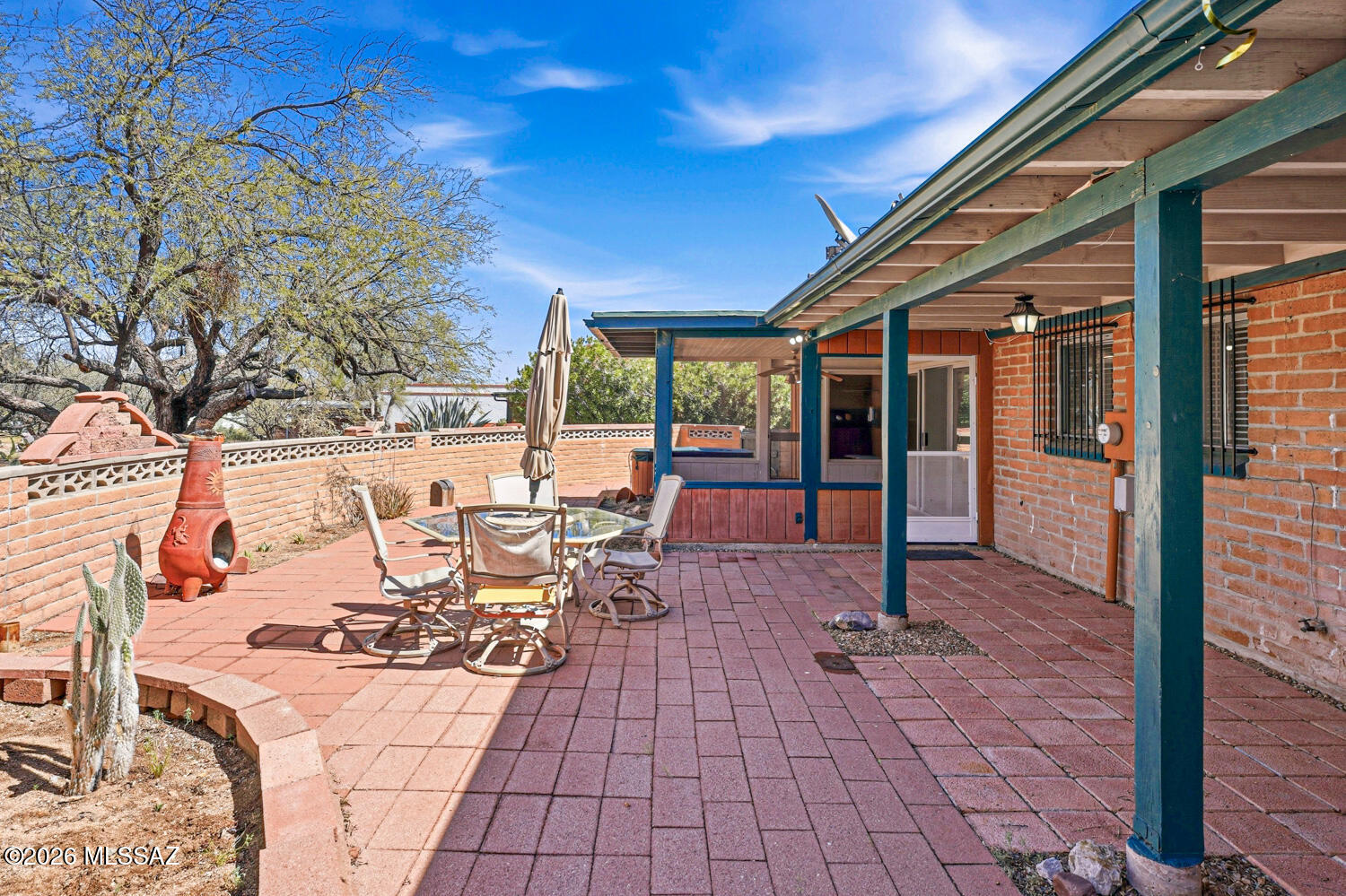 This bright 2-bedroom, 2-bath home provides charm and thoughtful touches on a unique circular lot! Custom paint and natural light create a warm, welcoming atmosphere throughout the open living spaces.

The kitchen offers abundant cabinetry and countertops, a large pantry, and a breakfast bar. The living and dining areas flow easily for comfortable entertaining and connect to an Arizona room patio, perfect for enjoying Arizona's indoor-outdoor lifestyle.

In addition to the square footage reflected in the assessor's records, the home features approximately 400 square feet fully connected to the main space, including a large laundry room with an adjoining flex area ideal for a home office, hobby room, or extra storage-providing added versatility and value. The home has also benefited several important system upgrades. Copper plumbing runs throughout the home, the drains have been professionally re-lined with clean-outs installed for easy maintenance, and the roof was recoated in 2024. In the backyard, all patio pavers were reset to create a smooth, step-free outdoor space, enhancing accessibility and usability.

Outside, enjoy low-maintenance desert landscaping in the front yard and a private backyard designed for easy living, featuring paver patios and a shaded wood-beam patio cover with a hot tub--perfect for relaxing while taking in the natural desert views. A convenient 2-car carport adds everyday practicality.

Located in a peaceful neighborhood surrounded by the beauty of the desert yet just minutes from shopping and dining, this clean, well-maintained home offers comfort, character, valuable upgrades, and extra usable space. Homes with this much charm and flexibility don't come along often-don't miss the opportunity to make it yours!