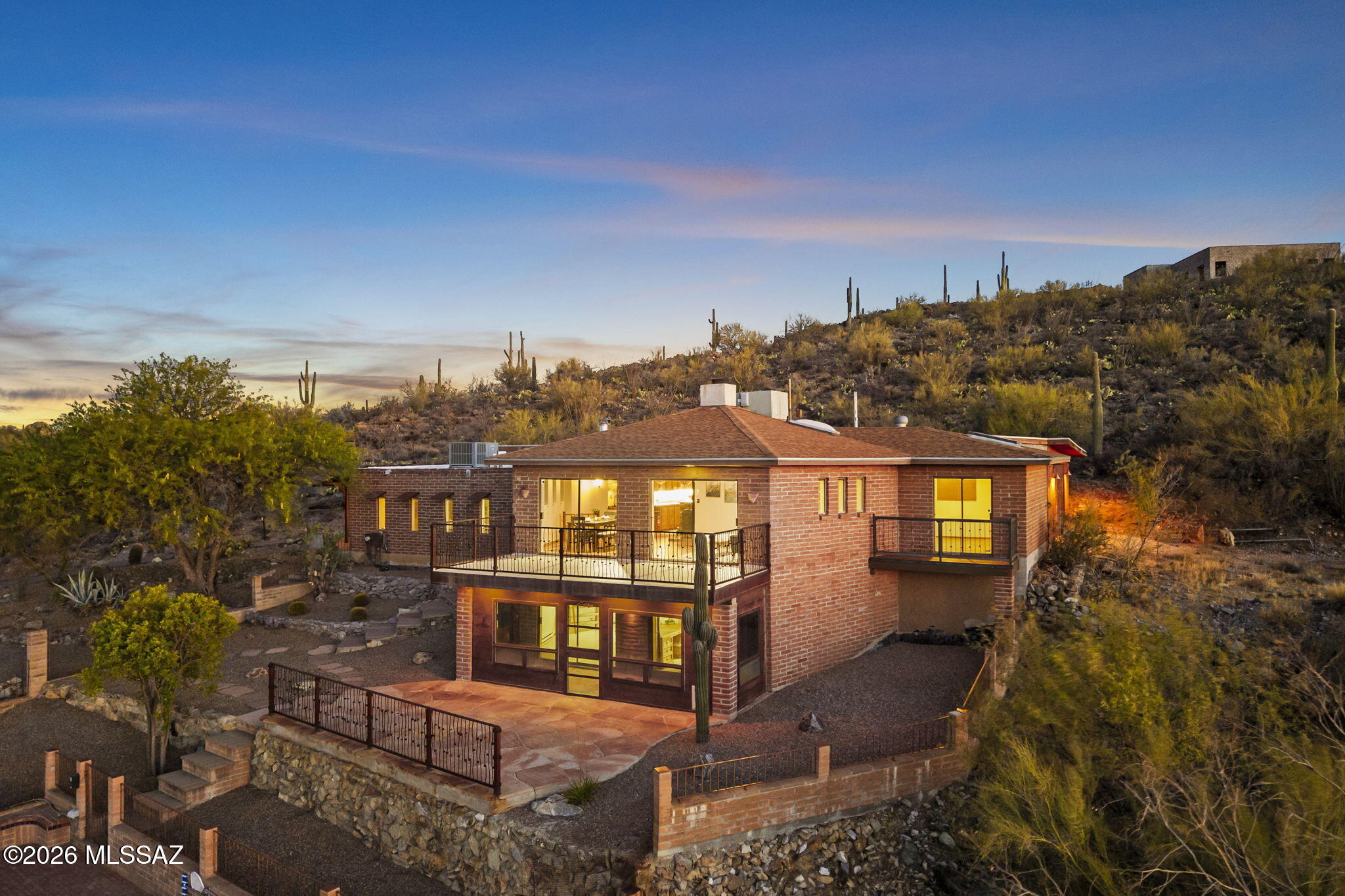 Tucked behind a gated entry at 4335 W Irvington Rd, this solid, well-built home on 4.56 acres is unlike anything you have seen before! Built to last with timeless burnt adobe construction, it features striking custom steel additions throughout that give it incredible, individual character. It is designed w/ everything you need, offering 2 bedrooms, & 2.5 baths. Large living room with fireplace & separate living & hobby room too. Massive windows & two private balconies frame endless, beautiful mountain views. The outdoor space features a refreshing pool, & room for all your ideas! The property's ultimate hidden gem is a massive 6+car tandem garage you would never expect from the outside. Truly unique & packed with features, this property blends everyday comfort with an unforgettable layout.