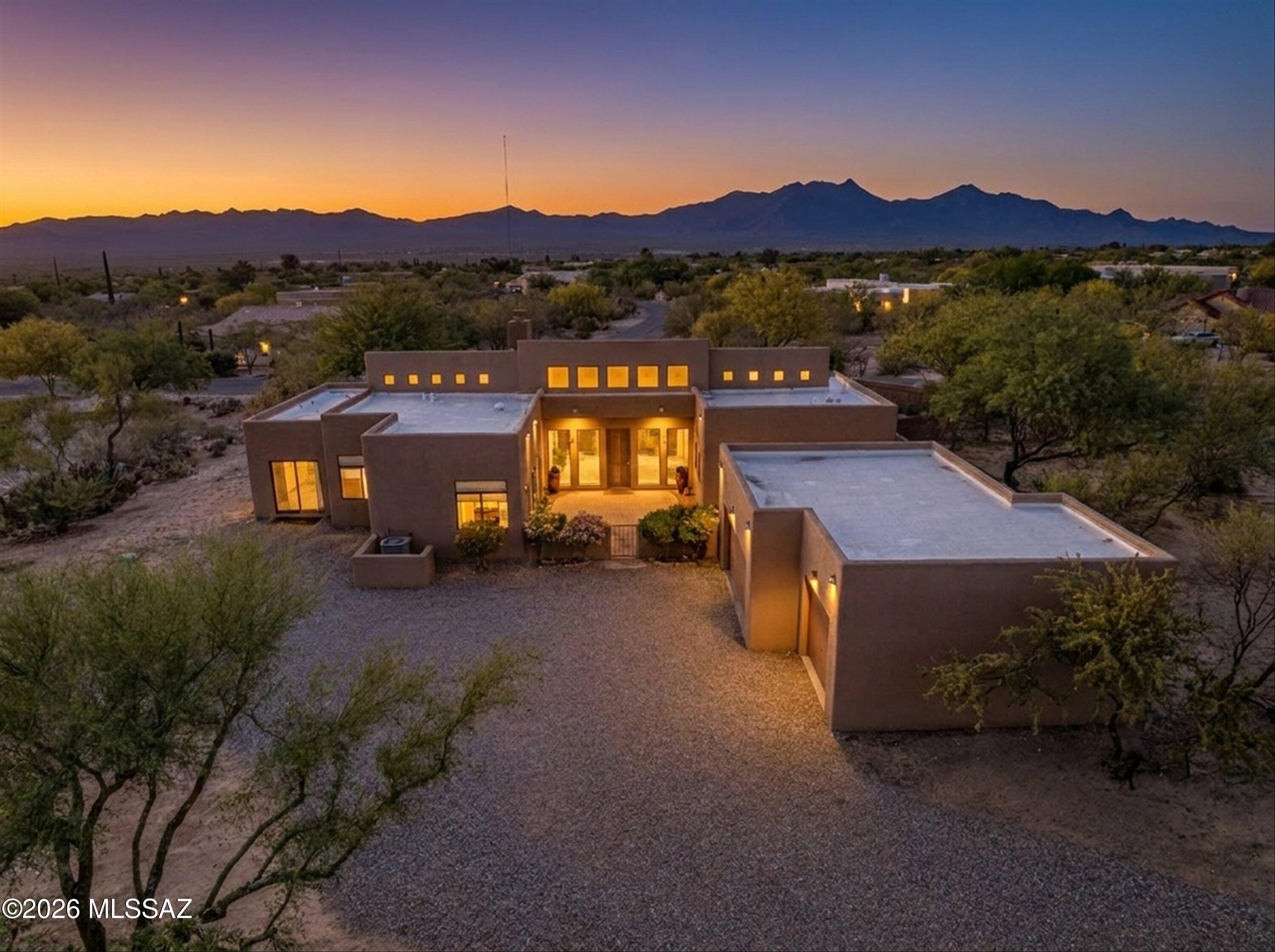 Situated on a spacious acre corner lot in the semi-custom community of Rancho Buena Vista, this single-story home offers the space, privacy, and lifestyle you have been daydreaming of. Surrounded by Santa Rita Mountain views, the fully enclosed front yard provides room to spread out, ideal for outdoor living, pets, and enjoying peaceful sunrise moments.
The back courtyard is designed for relaxation, capturing stunning sunset views and offering a private setting to unwind or entertain. A detached three-car garage and extended driveway provide ample parking and flexibility.
cont.. Inside, the home features a light and bright feel with high ceilings and abundant windows along with two wood burning fireplaces and an oversized tile shower in the primary bathroom suite. Thoughtfully designed flex spaces include an office nook or multipurpose area, plus a private bonus room off the primary suite, perfect for a nursery, fitness room, or additional workspace. The kitchen opens to a comfortable family room, creating a natural gathering space, while the larger laundry room adds everyday convenience. A side courtyard presents the opportunity to design your own outdoor kitchen or retreat.
Located in a smaller neighborhood with more space between homes, this property offers a peaceful, serene setting while remaining just minutes from all that Sahuarita and nearby Tucson have to offer. Ideal for those looking to transition from a traditional subdivision to a home with more room to live, relax, and create their own outdoor lifestyle.