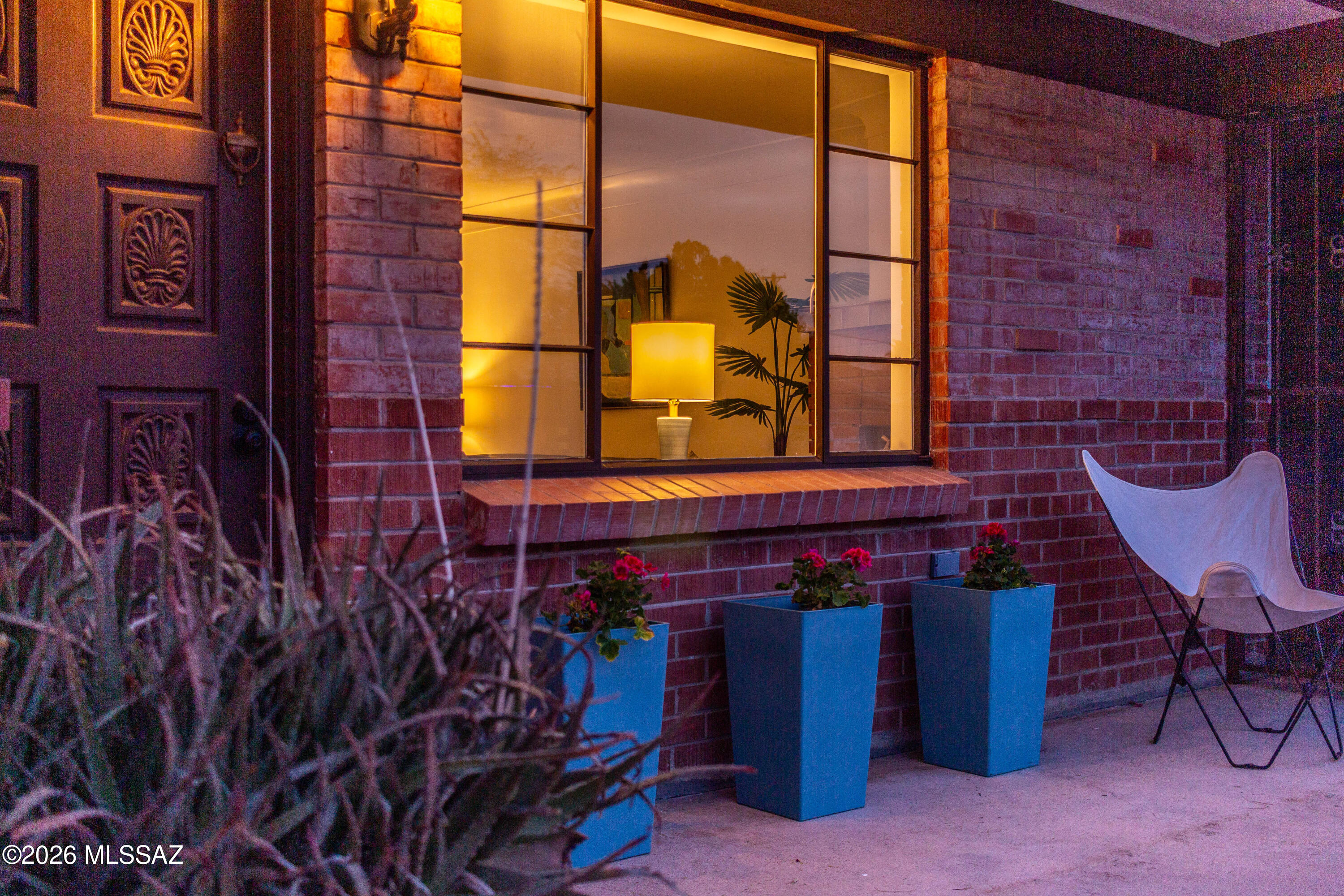 Tucson Association of Realtors HOME TOUR WINNER! This home is all about the details. Step into an inviting living room where a cozy red brick fireplace and cove ceiling create a welcoming atmosphere. The spacious kitchen has been thoughtfully upgraded with custom espresso cabinetry, large-format tile counters, with modern aluminum edging. Attention to detail continues throughout the home, with beautifully selected finishes in the bathrooms and easy-care tile flooring throughout. Outdoors, the oversized covered patio and mature shade tree create an ideal setting for gathering with friends and family. Storage options include a garage and a shed built on a concrete slab. This move-in ready midcentury home is tucked into a quiet yet centrally located neighborhood with convenient access to shopping, dining & parks.