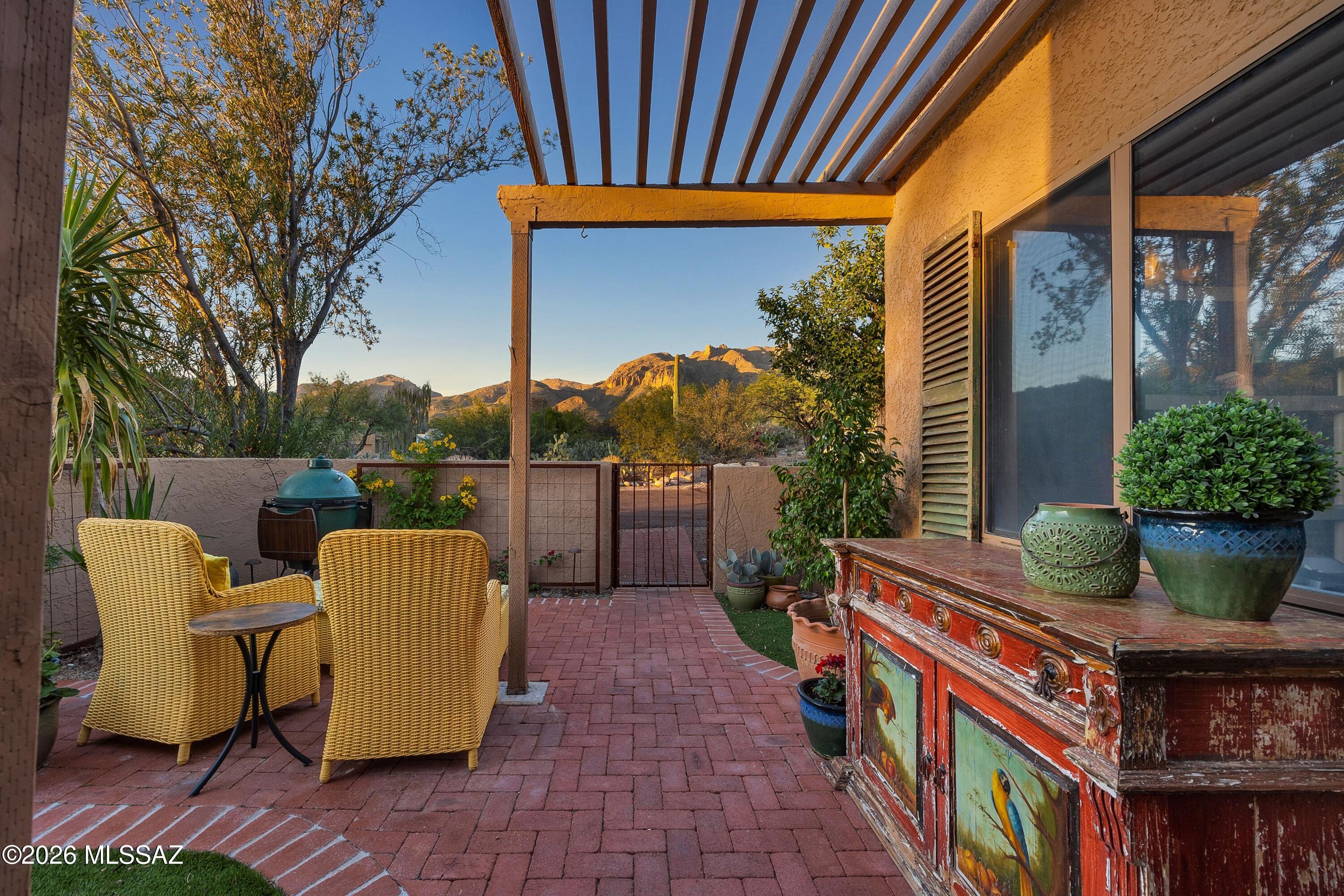 Extensively renovated one-level (no steps) townhome with a prime location in the heart of the Catalina Foothills, offers an exceptional combination of refined design, unobstructed mountain and city views, and convenience to Tucson's finest restaurants, shopping and world-class golf resorts. Up-close Catalina Mountain views from the front courtyard and city and sunset views from the private back patio. Over a three-year period, the current owner completed a comprehensive indoor and outdoor renovation, including a new heated plunge pool. Major system updates include a new HVAC system (2022), a new water heater (2024), roof re-coating (2025), new gutters, and a new electrical panel.The front courtyard was redesigned by landscape architects Terra Designs...CONTINUED with new red brick pavers, irrigation, artificial turf, custom metal paneling, and outdoor lighting. The backyard/patio was transformed into a private retreat with the addition of a new in-ground heated plunge pool, travertine-paver patio, custom fencing, metal accents, and a beautiful cactus garden. Just beyond the backyard is a wide open space with natural desert creating true privacy and direct access to walking trails.
Inside, the home was fully renovated to create an open, functional floor plan. New porcelain tile throughout, paint, lighting, ceiling fans, hardware, and custom window treatments including a large automatic Hunter Douglas shade at great room French doors & windows. New French doors were added to the primary bedroom, guest bedroom, and great room to enhance indoor-outdoor flow. Custom built-ins in the closets throughout the home by California Closets.
The professionally redesigned kitchen has been opened to the great room by removal of the separating wall, improving overall functionality and flow. The kitchen showcases high-end finishes and stainless steel appliances, including a built-in Thermador refrigerator. Additional highlights include custom cabinetry with glass-front doors and lit shelving, custom countertops, designer tile backsplash, new sink and fixtures, updated lighting and hardware, a walk-in pantry, and a new bar area with wine storage and custom backsplash. Enjoy up-close Catalina Mountain views from the kitchen sink.
The spacious primary suite with patio access offers a fully renovated bath featuring a dual-sink vanity, custom tile shower with glass enclosure, new fixtures, lighting, hardware, and finishes. The walk-in primary closet is outfitted with custom built-ins by California Closets.
The hall bath has been equally updated with a new vanity, custom tile surround, new fixtures, lighting, mirror, and hardware. Laundry room with custom California Closets built-in shelving for storage and new Speed Queen washer and dryer.