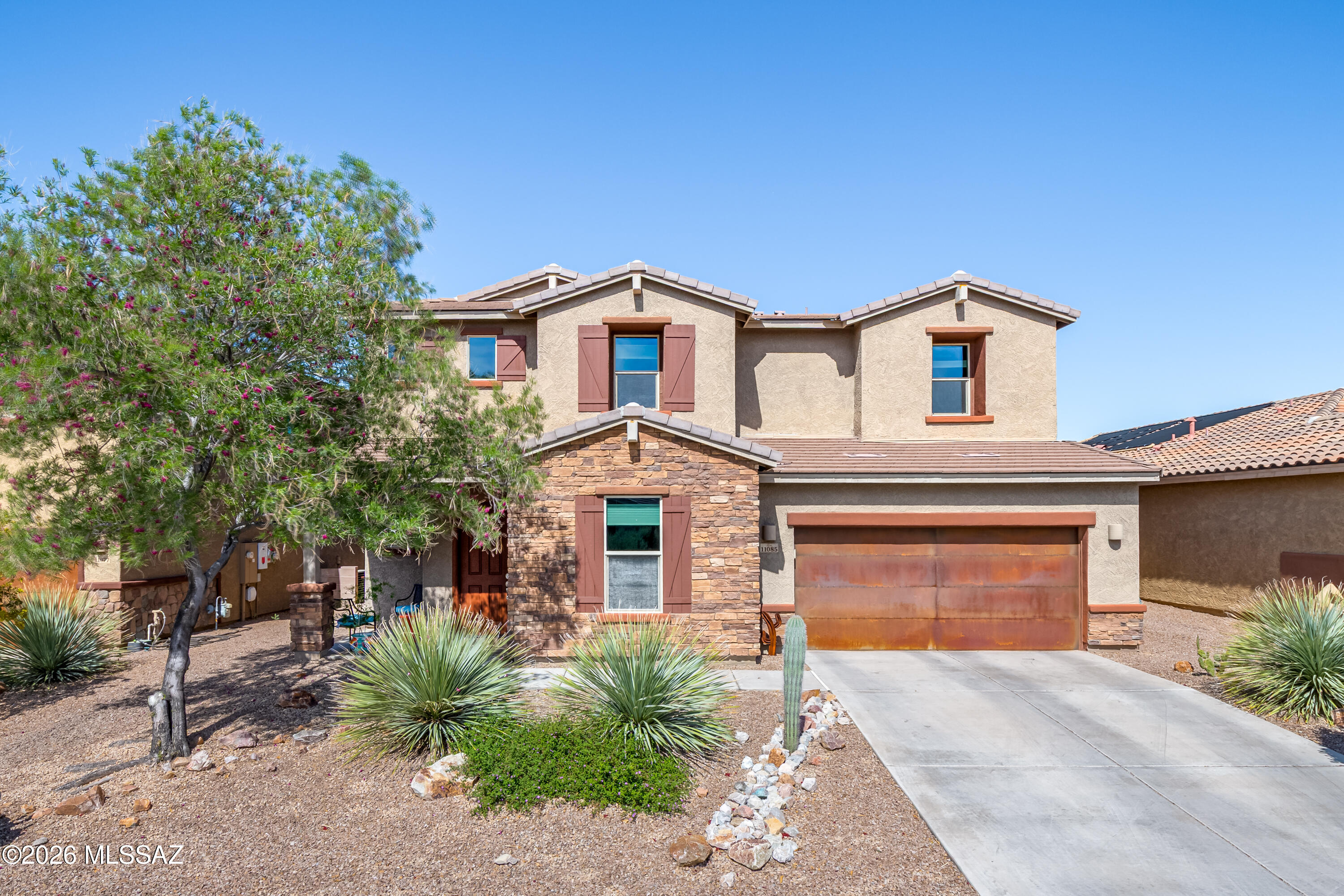 Beautifully designed newer 2017 Meritage Homes-built residence in the gated Estates at Capella community offers 2,887sf of thoughtfully planned living space with 4 bedrooms, 3½ baths, a private den, loft, pool & 3-car garage. Located in Oro Valley ranked the #1 safest city in Arizona by SafeWise in 2025, this home delivers an exceptional blend of comfort, style & lifestyle. Designed with modern living in mind, the home features 10-foot ceilings, 8-foot doors, and elegant architectural details throughout. The expansive chef's kitchen is the centerpiece, showcasing linen white cabinetry, newer granite countertops, a striking Italian marble backsplash, updated cabinet hardware, large center island, walk-in pantry & convenient pocket office. The open layout flows seamlessly into the bright great room, where large windows frame the backyard and create effortless indoor-outdoor living. Step outside to your private retreat, complete with an extended covered patio and a sparkling saltwater pool with in-floor cleaning system and pebble sheen finish perfect for relaxing or entertaining in the Arizona sunshine. Upstairs a luxurious primary suite offers a spacious walk-in closet and spa-inspired bath, while additional bedrooms, a convenient laundry room, and a versatile loft provide flexible living space for a game room, media area, or family lounge. Downstairs, a private den creates the ideal home office, study, or hobby room. Thoughtful upgrades continue with custom mudroom storage cubbies and built-in seating, enhancing everyday functionality. The Estates at Capella community is gated, beautifully maintained, and designed for connection, featuring a neighborhood park, sidewalks, and walking paths, along with regular community gatherings, movie nights, and seasonal events. Residents also enjoy direct access to Poppy Trail, a scenic route popular for walking and biking. Conveniently located within walking distance to highly regarded schools including Wilson K-8 School and Ironwood Ridge High School, the home is also close to shopping, dining & everyday essentials. Oro Valley is known for its well-maintained roads, responsive town services, and abundance of parks, trails and recreational opportunities, making it one of Southern Arizona's most desirable places to live. This exceptional property combines energy-efficient construction, extensive upgrades, and a prime Oro Valley location, offering the perfect opportunity to enjoy the very best of desert living.
