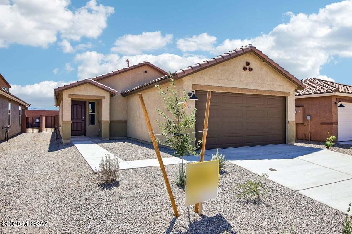 This home is open for self-guided tours daily 8 am - 8 pm. This single-story home features an open floor plan with ceramic tile flooring throughout. Overlooking the great room, the kitchen boasts granite countertops, dark brown cabinets, a peninsula, pantry and Whirlpool® stainless steel appliances, including electric range and dishwasher. The primary bedroom showcases a walk-in closet and connecting bath with a dual-sink vanity and walk-in shower. The covered back patio provides outdoor shade. Price includes discount predicated on using seller's preferred lender KBHS.
