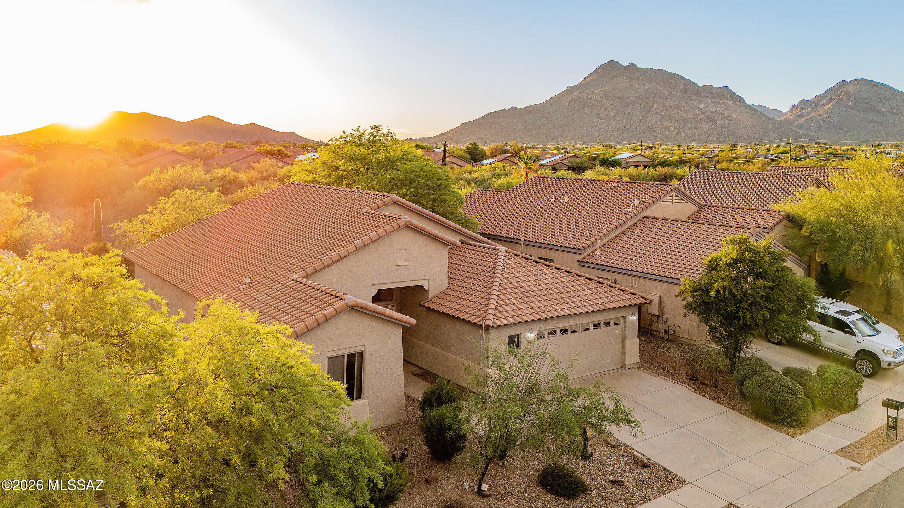 Set against the stunning desert landscape of Southwest Tucson, this well maintained home offers sweeping mountain views, peaceful surroundings, and a spacious open layout designed for comfortable everyday living. Located in a quiet neighborhood with easy access to outdoor recreation, the property captures the beauty of the Sonoran Desert from nearly every angle.
A private courtyard entry welcomes you into a bright interior filled with natural light, soaring ceilings, and expansive living spaces. The open concept design flows seamlessly between the living room, dining area, and kitchen, creating an inviting space for entertaining or relaxing at home. Wood look tile flooring throughout the main living areas adds warmth and durability, while large windows showcase the surrounding desert The spacious kitchen offers abundant cabinetry, generous counter space, stainless steel appliances, and a large breakfast bar that overlooks the main living area, making it perfect for both everyday living and entertaining. The split bedroom floor plan provides privacy, while the spacious primary suite offers a relaxing retreat with an ensuite bath and walk in closet.

Step outside to enjoy a covered patio and a beautifully landscaped backyard featuring low maintenance desert landscaping, artificial turf, and breathtaking mountain views. Backing to natural desert, the outdoor space offers exceptional privacy and the perfect setting to enjoy Arizona's spectacular sunsets and peaceful surroundings.

Conveniently located near shopping, dining, golf, hiking trails, and other outdoor recreation, this home combines comfort, functionality, and the natural beauty of the Sonoran Desert. Schedule a tour today!