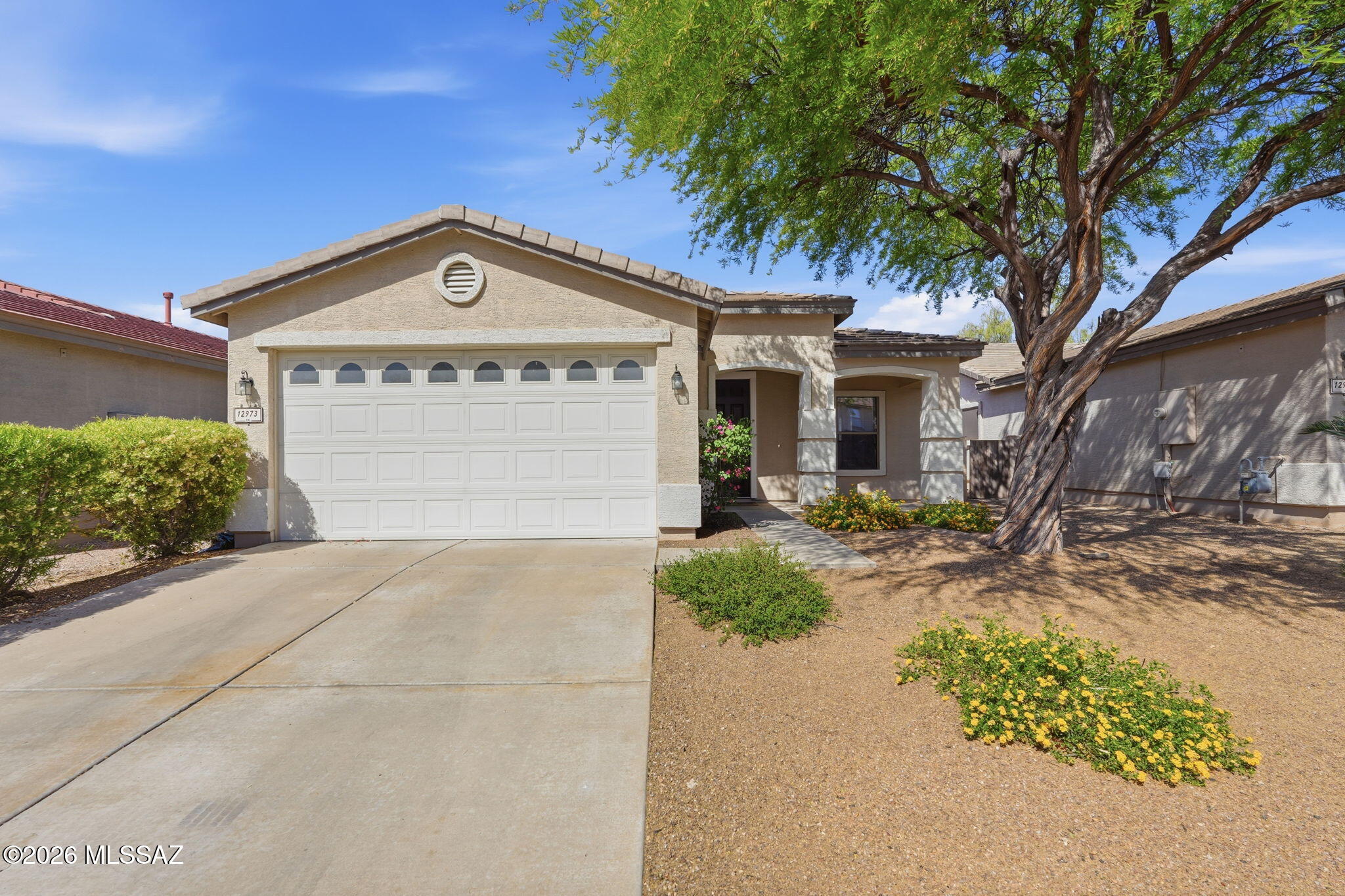 1669 sq ft home in Oro Valley, NW Tucson. Spacious floorplan with 3 bedrooms, 2 baths, family room and living room with great room concept, nice size backyard with a covered patio, block wall and built-in BBQ,, and a 2-car garage. Kitchen features granite countertops, stainless appliances and kitchen island for expanded prep space and seating. This location puts everything within a super convenient distance. Dining, shopping, and the Oro Valley Marketplace are just minutes away, along with nearby hospital facilities for added peace of mind. Oro Valley has been ranked in the top 3 cities to live in, and it's easy to see why. Embrace an active lifestyle with nearby bike paths, scenic parks, and  nature trails, and take in those amazing Arizona sunsets all within your own community!