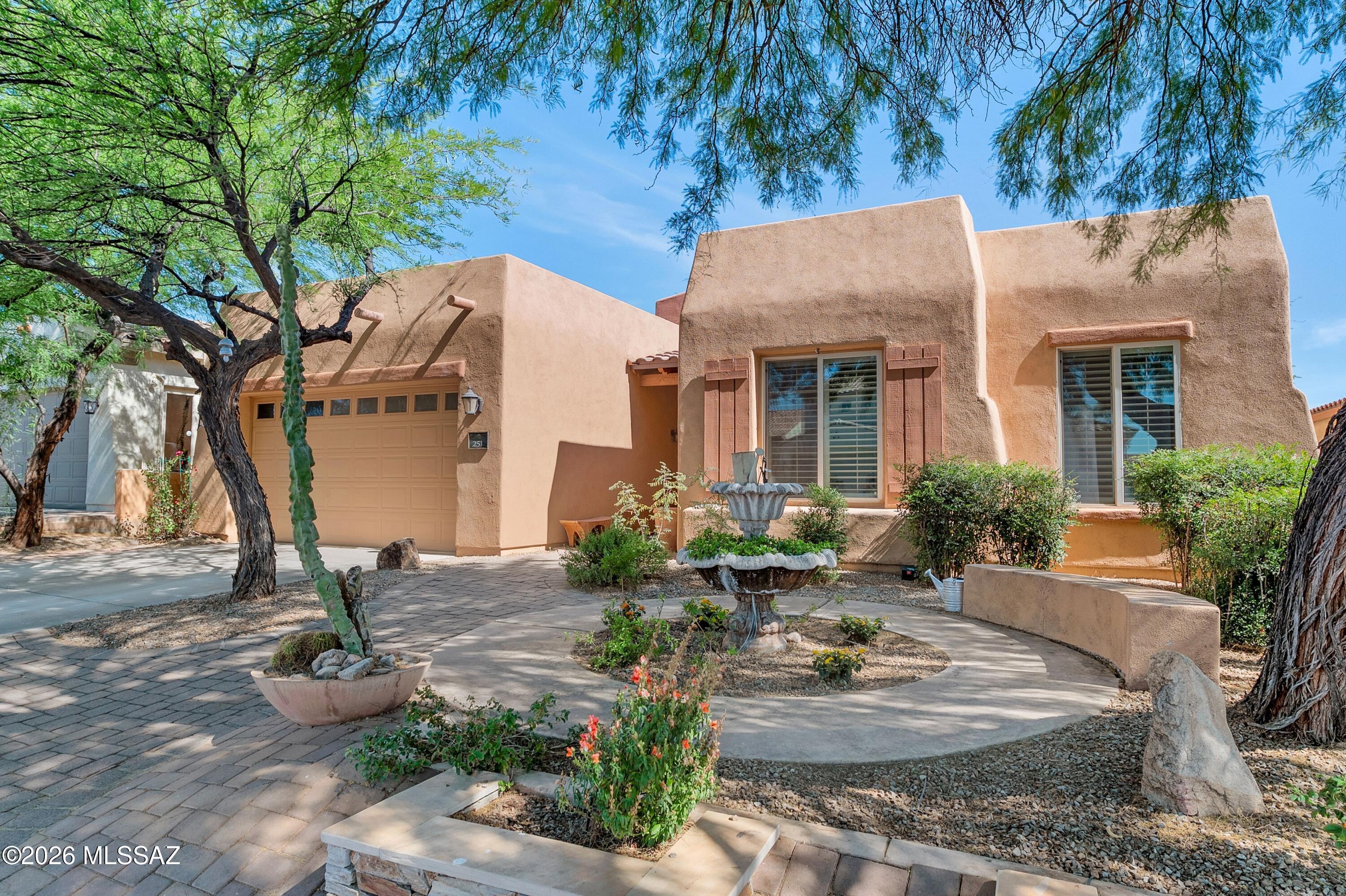 VA assumable at 4.99%. Thoughtfully designed floorplan is in the heart of Sahuarita offers space, & charm. Spacious 4-bedroom home with additional flex room features soaring ceilings, multiple living spaces, and a stunning dual-sided fireplace that creates a warm and inviting connection between the family room and sitting room. The kitchen is designed for both functionality and entertaining with abundant cabinetry, pull-out shelving, breakfast bar seating, bay window dining nook, Corian countertops, and a brand-new dishwasher. Step outside to a backyard designed for both relaxation and fun, complete with mature landscaping, covered patio space, and a built-in tree house that adds a unique touch the whole family will love. The roof has been fully replaced within the last two years. Addition highlights include ceiling fans throughout, central vacuum system, plantation shutters, garage storage cabinets with overhead storage, and no interior steps. Located within the highly desirable Rancho Sahuarita community, residents enjoy access to parks, pools, walking trails, recreational facilities, lakes, playgrounds, and convenient access to I-19 for an easy commute.