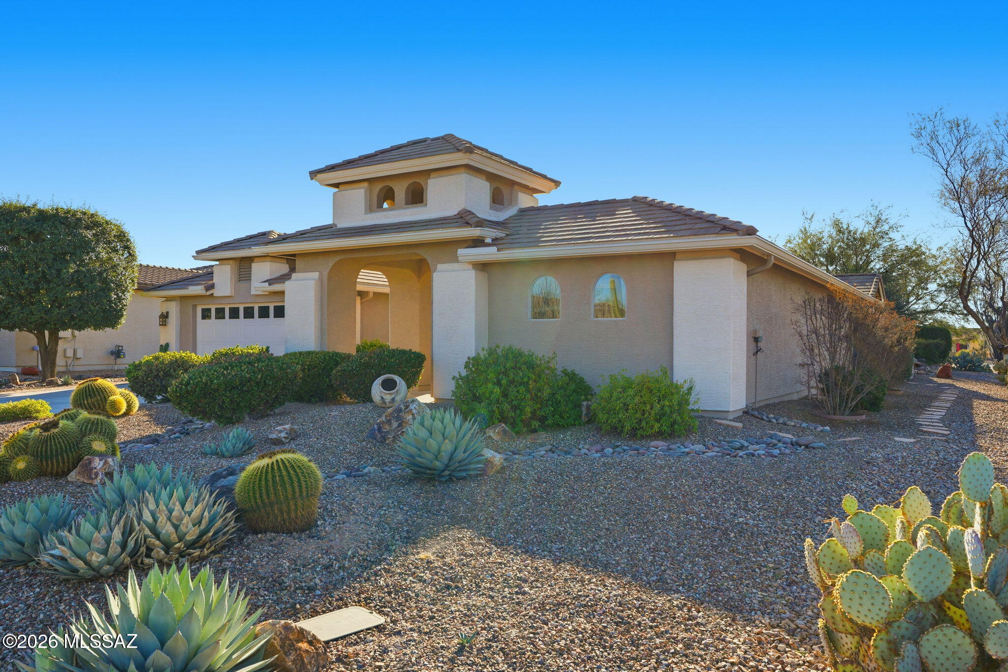 Meticulously maintained one-owner home loaded with upgrades! Flexible expanded floorplan creates a light & airy open dining & living room, office/den, breakfast nook, & family room with built-ins. The owner's en-suite features custom tile & two closets. The guest bedroom expansion includes a built-in queen murphy bed and space for hobbies. The kitchen features soft-close Knotty Cherry cabinets, stainless appliances, gas top with convection oven, built-in microwave, pantry, and solid surface countertops.  The laundry room cabinets provide additional storage. Easy care 4'' plantation shutters & 22'' tile flooring throughout. Ceiling fans in almost every room and solar panels help keep your cooling costs low! Extended 2-car garage has utility sink, loads of cabinets, & epoxy floor for easy clean up!  The extended golf cart garage provides more storage & easily doubles as a workshop or hobby studio! Enjoy outdoor living at its finest - from the peaceful & private front courtyard complete with a tranquil fountain to the  professionally landscaped backyard featuring an expanded covered patio, privacy screen, pergola, and view of the Santa Rita mountains while relaxing by the rock waterfall!  Solar Lease $71/m (approx. $5,200). TEP approx. $35/mo.