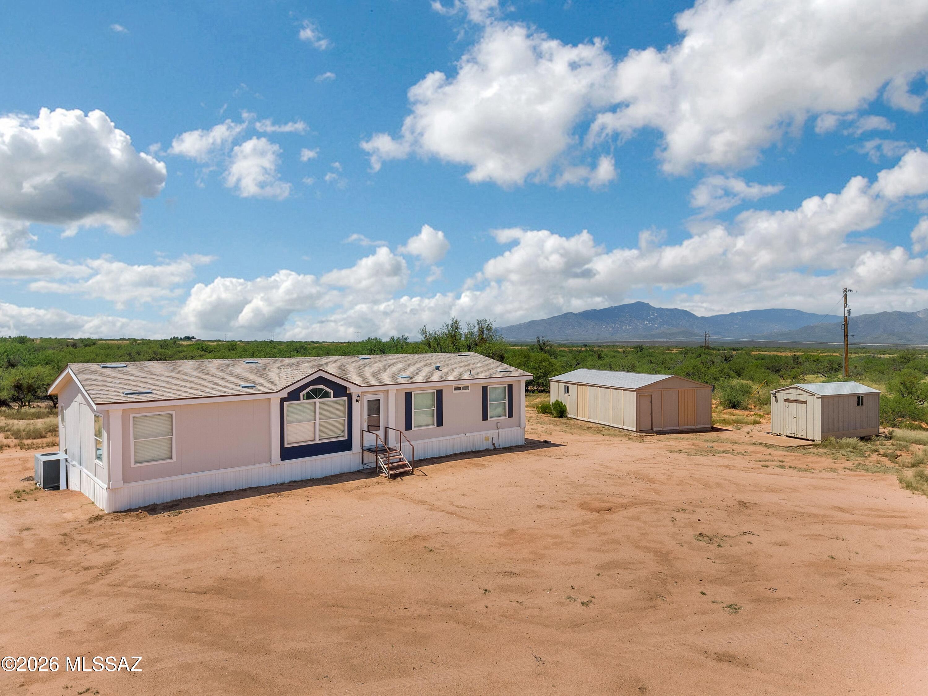 Enjoy the freedom and tranquility of country living on 3.6 acres in Benson. This well-maintained home offers privacy, wide-open space, and beautiful mountain views, with spectacular sunrises and sunsets to enjoy from your own property. The usable acreage provides plenty of room for a garden, animals, outdoor activities, or creating your own peaceful rural retreat. An 18' x 32' workshop and additional storage shed provide ample space for projects, hobbies, tools, and equipment. Whether you're looking for room to spread out, space for your animals, or simply a quiet place to enjoy the outdoors, this property offers the best of rural living while remaining conveniently located near interstate access.