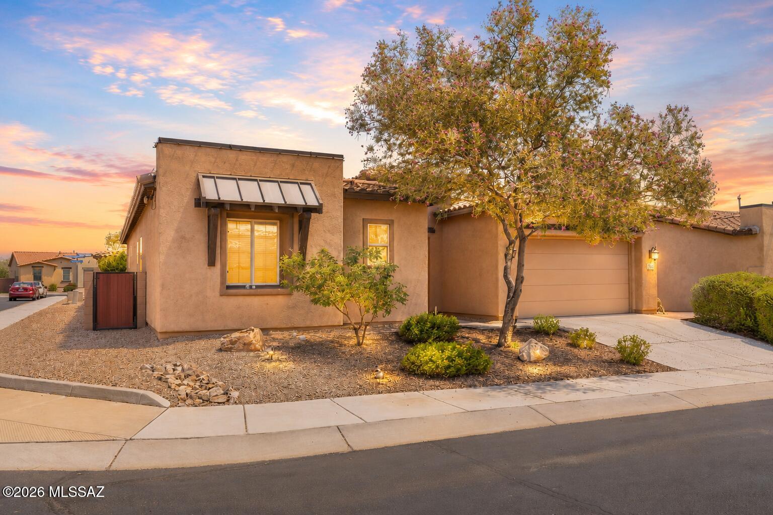 Welcome to this stunning Richmond American home nestled on a premium corner lot in the sought-after Santa Cruz Meadows community in Sahuarita. Offering 2,537 square feet of thoughtfully designed living space, this 3-bedroom, 2.5-bathroom home with a den/bonus room delivers an exceptional blend of style, comfort, and functionality -- all with a remarkably low $18/month HOA.
From the moment you arrive, the custom front security door and outdoor permanent programmable lighting with color-changing features set the tone for the upgrades found throughout. Step inside to soaring 10-foot ceilings and stunning marble-look porcelain tile 2'×4' that flows seamlessly through the entire home. The main living area is a showstopper, featuring tray ceilings with 6'' crown molding, custom built-ins, High-end 78" linear electric fireplace with adjustable flame and ember color options. A dramatic 12-foot slider door with electric Levolor blinds opens to the backyard oasis, creating effortless indoor-outdoor living.
The chef's kitchen is designed to impress, boasting 42" cabinetry with custom stone and granite countertops, a large center island, extended counter space for additional prep and storage, a 5-burner stove, double oven, French door refrigerator, and a walk-in pantry. A butler's pantry with a dry bar station and mini fridge adds a touch of luxury perfect for entertaining. The formal dining area, breakfast nook, and breakfast bar provide plenty of options for every occasion.
Retreat to the spacious primary suite, complete with a bay window, tray ceilings with crown molding, a custom walk-in shower, ceiling fan, and a custom walk-in closet with new carpet. Two additional bedrooms and a versatile den/bonus room each feature recessed lighting, ceiling fans, and walk-in closets -- ideal for guests, a home office, or flex space.
The two-car garage impresses with an extended layout and four large overhead storage racks, while the laundry room offers front-loading washer and dryer with built-in shelving. A conveniently located powder room rounds out the interior.
Outside, the fully finished backyard is a private retreat featuring lush turf, elegant pavers, a decorative fountain, and professional landscaping -- ready for relaxing or entertaining year-round.
This home is truly move-in ready and packed with premium upgrades. Schedule your showing today!
