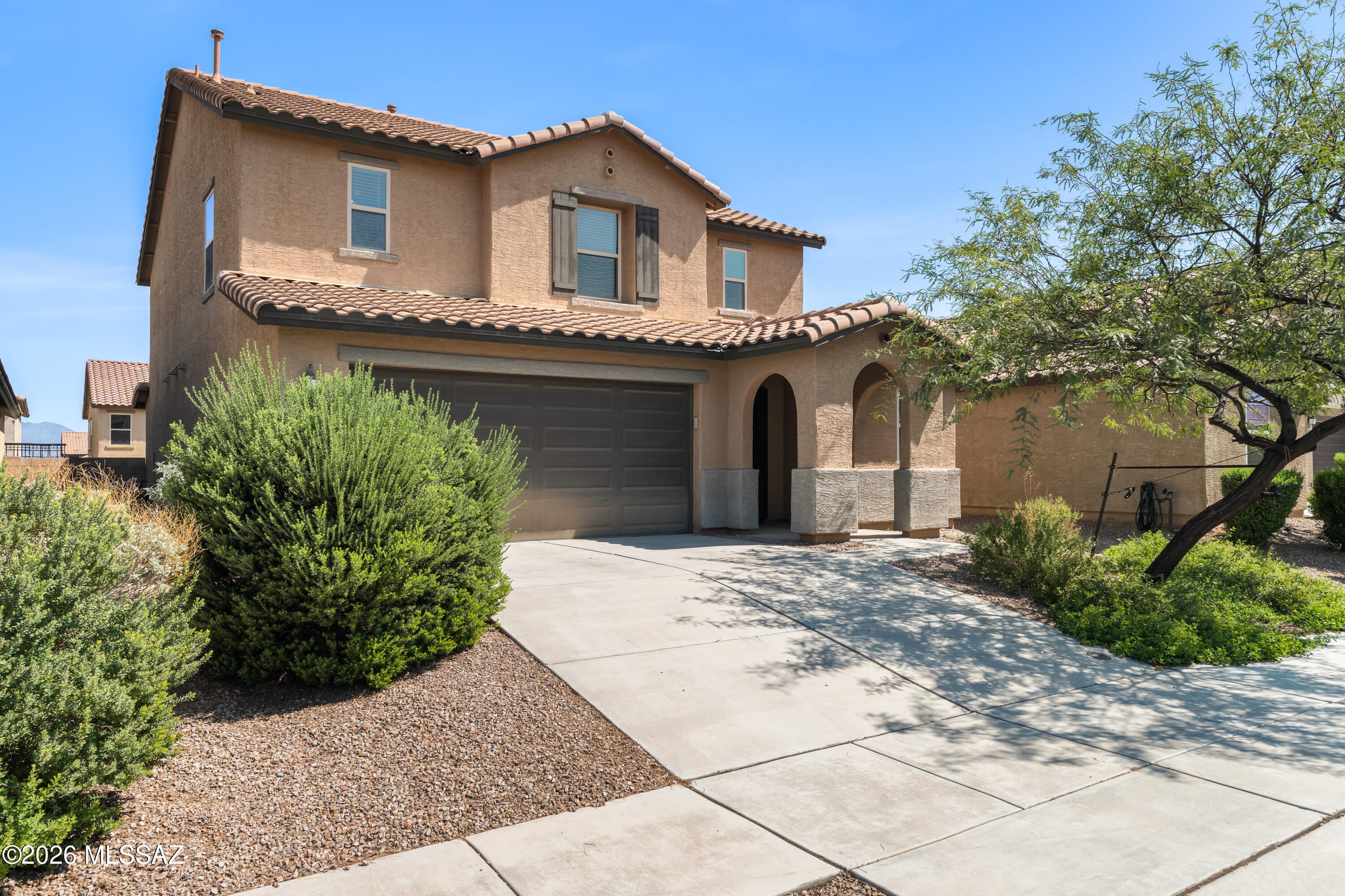 Welcome to a beautifully maintained one-owner home offering comfort, space, and style. This 4-bedroom, 3.5-bath, two-story residence features two primary suites, including one downstairs-ideal for guests or multigenerational living. The open kitchen boasts a large granite island, stainless steel appliances, extended-height cabinetry, and timeless finishes. Neutral tones and blinds throughout add to the inviting feel. Upstairs features a spacious loft with an alcove, perfect for an office or study area. The luxurious owner's suite offers a spa-inspired bath with a walk-in shower and dual vanity. Outside, enjoy a landscaped backyard with pavers, turf, raised garden beds, mature landscaping, a relaxing jacuzzi, and a patio with a gas line for your grill.Move-in ready and impeccably cared for!