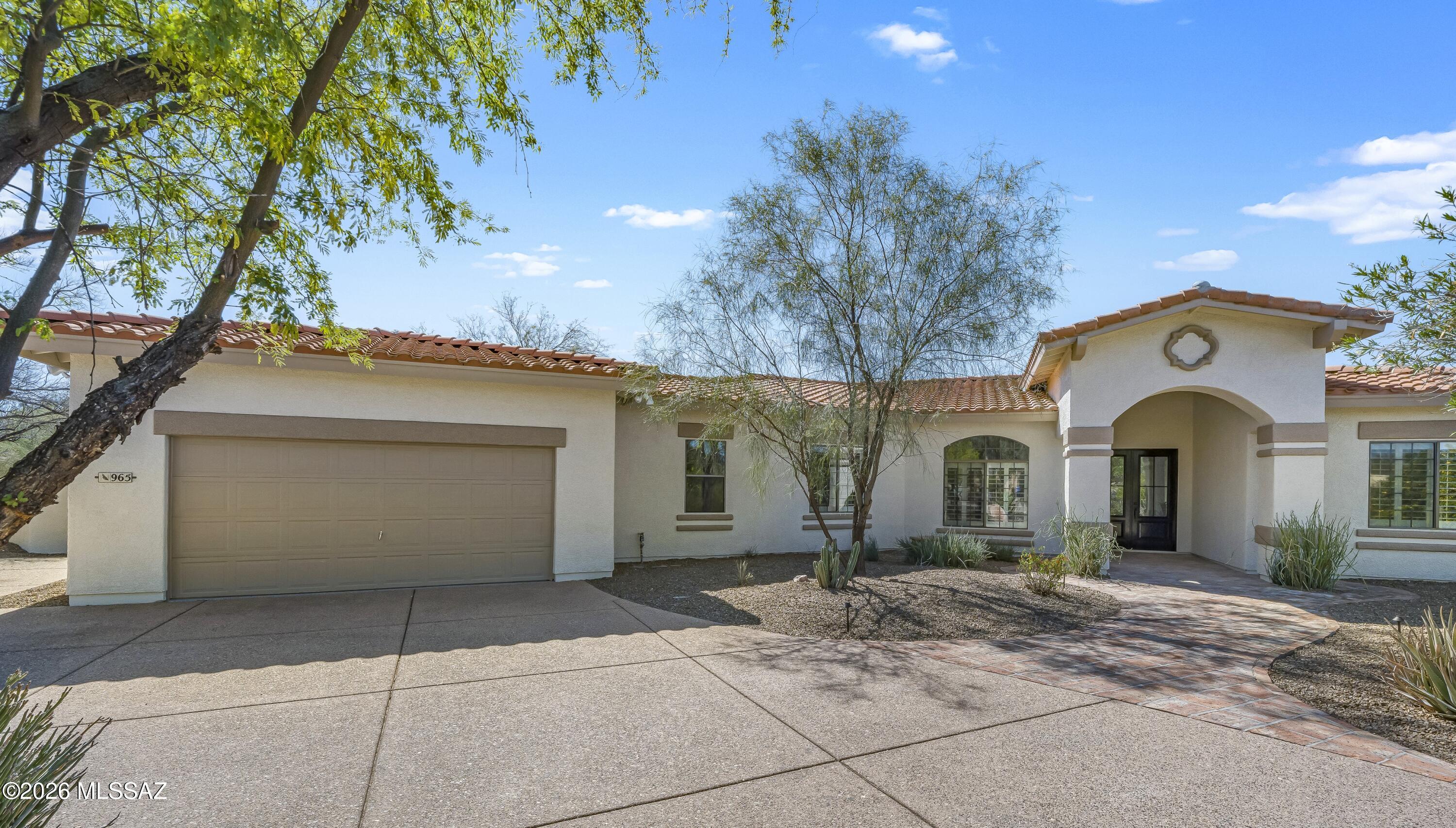 Completely reimagined from top to bottom, this gorgeous showstopper home & casita deliver next-level style, space & Tucson luxury. Every inch has been redone! Striking curb appeal w/circular drive & grand dbl-door entry into a dramatic foyer. Stunning designer island kitchen w/rich cabinetry, quartz counters & SS appl is open to an expansive greatroom w/FP & French doors. Formal living & dining rooms elevate entertaining. Primary retreat feels like a boutique resort w/soaking tub, oversized shower, dual sinks & walk-in closet. Outside, your private oasis awaits: sparkling pebble-tec pool, kiva FP, built-in BBQ & serene pond. Casita offers lg living area, bedroom & full bath, ideal for guests, ofc, gym or art studio.  Situated in a quiet cul-de-sac in the Casas Adobes coveted Pomelo Estates