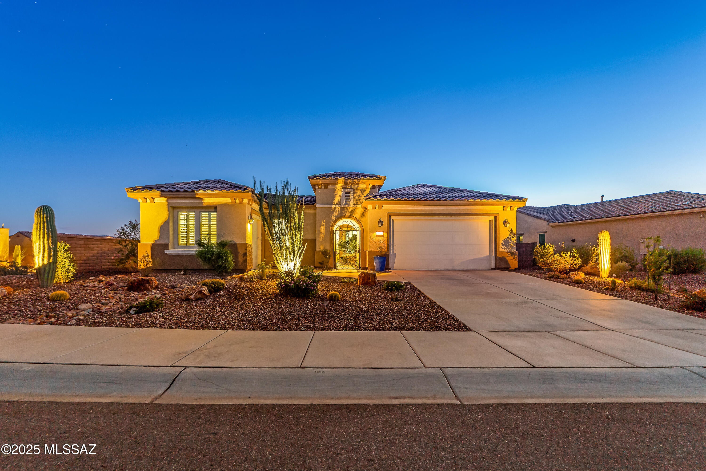One of the most-incredible homes in Del Webb Dove Mountain has become available. 365 gorgeous sunsets every year! Journey model, perched high on amazing, private, view (corner) lot w/ nobody behind. Old-world charm meets modern convenience. Better-than-new, sparkling clean w/ highly upgraded white Quartz countertops, porcelain tile, cultured marble, bedroom carpet-all in pristine condition. Split floor plan with 2 en-suites, alarm system, den, TV room, high-end window treatments, tankless hot water, whole home air purification, amazing surround sound (inside & out), water softener and extra-long, heated pool w/ panoramic view! Gorgeous fireplace inside and built-in grill and amazing fire-feature outside. 3rd garage for the golf cart. Walking distance to Del Webb Community Center amenities.