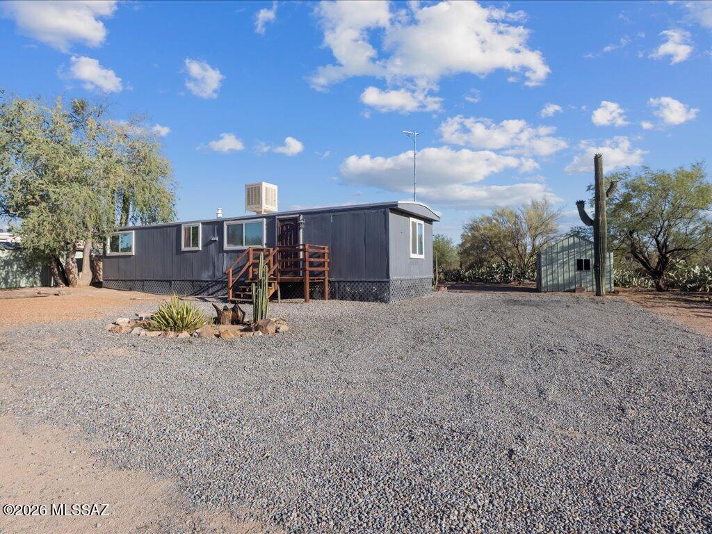 Affordable desert living on a one acre lot next to Saguaro National Park in the Picture Rocks area. Nicely remodeled single-wide and no HOA. Move in ready! Income potential with a full RV hookup and zoned for an additional manufactured home.