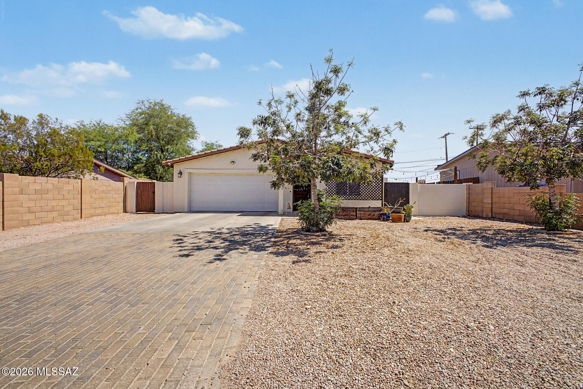 Take advantage of this fantastic opportunity! This 3-bedroom, 2-bath property welcomes you with a 2-car garage and an extended paver driveway. Inside, you'll find a serene living room with a soothing palette and durable tile flooring for easy maintenance. The gourmet kitchen comes with granite counters, ample wood cabinetry with crown moulding, recessed lighting, a mosaic tile backsplash, stainless steel appliances, and a peninsula with a breakfast bar. The main bedroom includes a private bathroom with double sinks and a convenient walk-in closet. Venture out onto the charming backyard, complete with a covered patio, low-maintenance artificial turf, and a covered patio for dining al fresco or refreshing drinks. Don't miss out on this one!