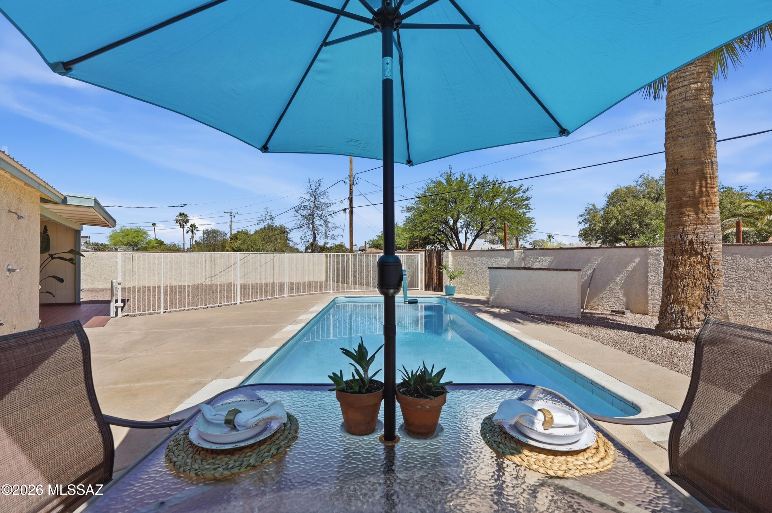 Pool, parking, central location, and no HOA -- this Tucson home packs in the features buyers are searching for! Enjoy mountain views, double gate access (secure parking for toys, trailer, or extra vehicles), and a spacious backyard with a sparkling pool, covered patio, and room to relax or entertain. North/South exposure (shaded backyard living during summer months). Inside, the layout offers comfortable everyday living with updated finishes and all appliances included. Conveniently located near Udall Park, The Loop, TMC, shopping & dining. Whether you're looking for a full-time home, winter getaway, or investment opportunity, this property offers flexibility, functionality, and value in a highly convenient location.