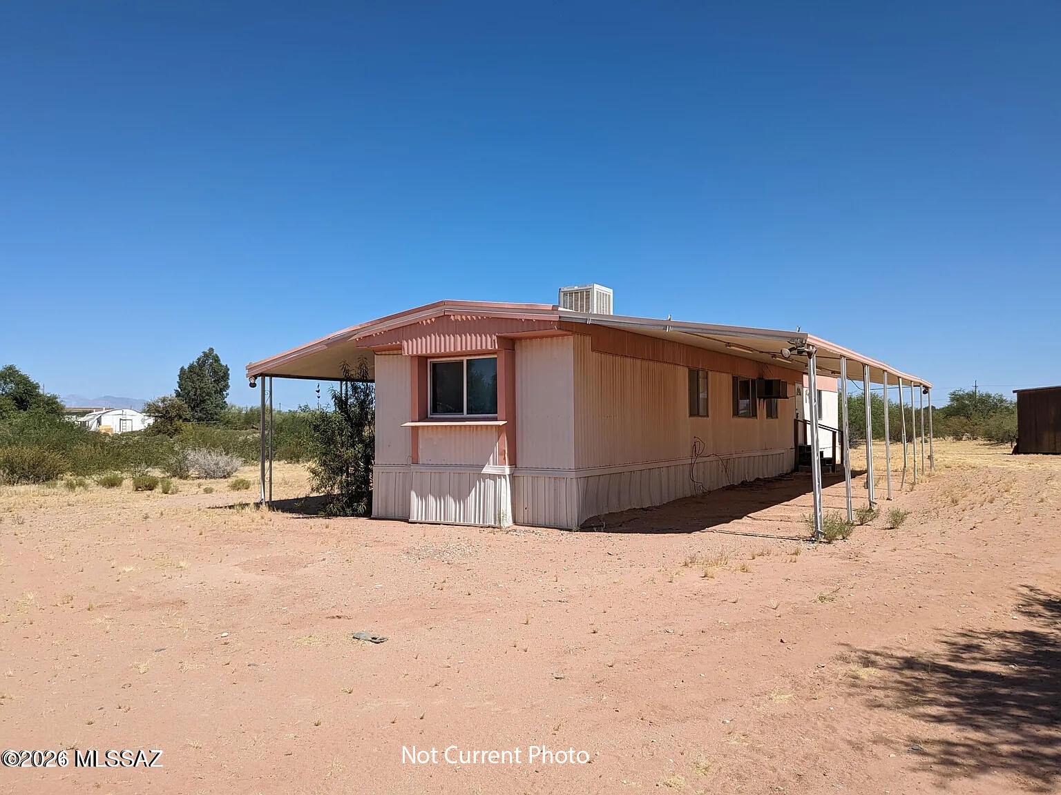 Check out this lovely 3 bed, 2 bath mobile home now for sale in Marana! Featuring carport parking, a convenient storage shed, and a cozy porch, it's sure to be the one for you! Inside you will find a sizeable dining & living area W/soft carpet in all the right places, wood paneling, and beamed ceilings. The kitchen comes equipped w/plenty of cabinet & counter space for all your cooking needs. The primary suite also includes its own private bath for added comfort & convenience! What are you waiting for? Don't let this great opportunity get away!