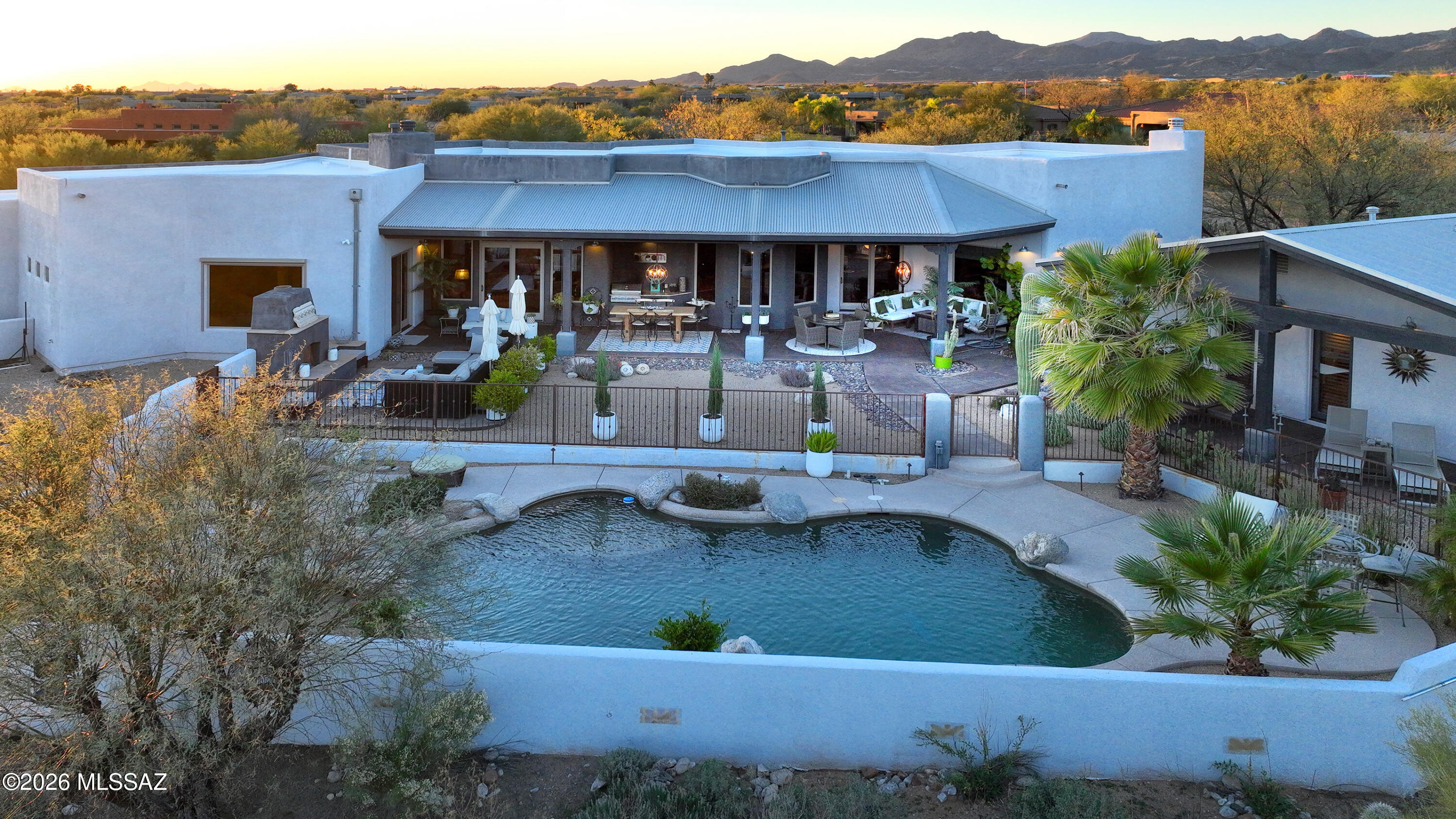 Seller is accepting back-up offers. Prime Oro Valley location!. This custom Southwestern luxury home sits well east of La Canada on a very peaceful and private 1.29-acre lot with unobstructed Catalina Mountain views and no HOA! 4,261 sq ft, 3 bedrooms and 4 baths in the main house, plus a 780 sq ft casita/pool house Enjoy a true chef's kitchen with Thermador and Dacor appliances, double ovens, 48'' gas cooktop, a massive island, two sinks, two dishwashers, wet bar, Subzero wine cooler, and high-end custom cabinetry. Spacious great room. The large family room and office both feature more beautiful custom cabinetry. 4 fireplaces. Split bedroom plan with an impressive master suite and en-suite bedrooms, two laundry rooms. Amazing outdoor living spaces, beautiful pool & spa, BBQ. 3 car garage