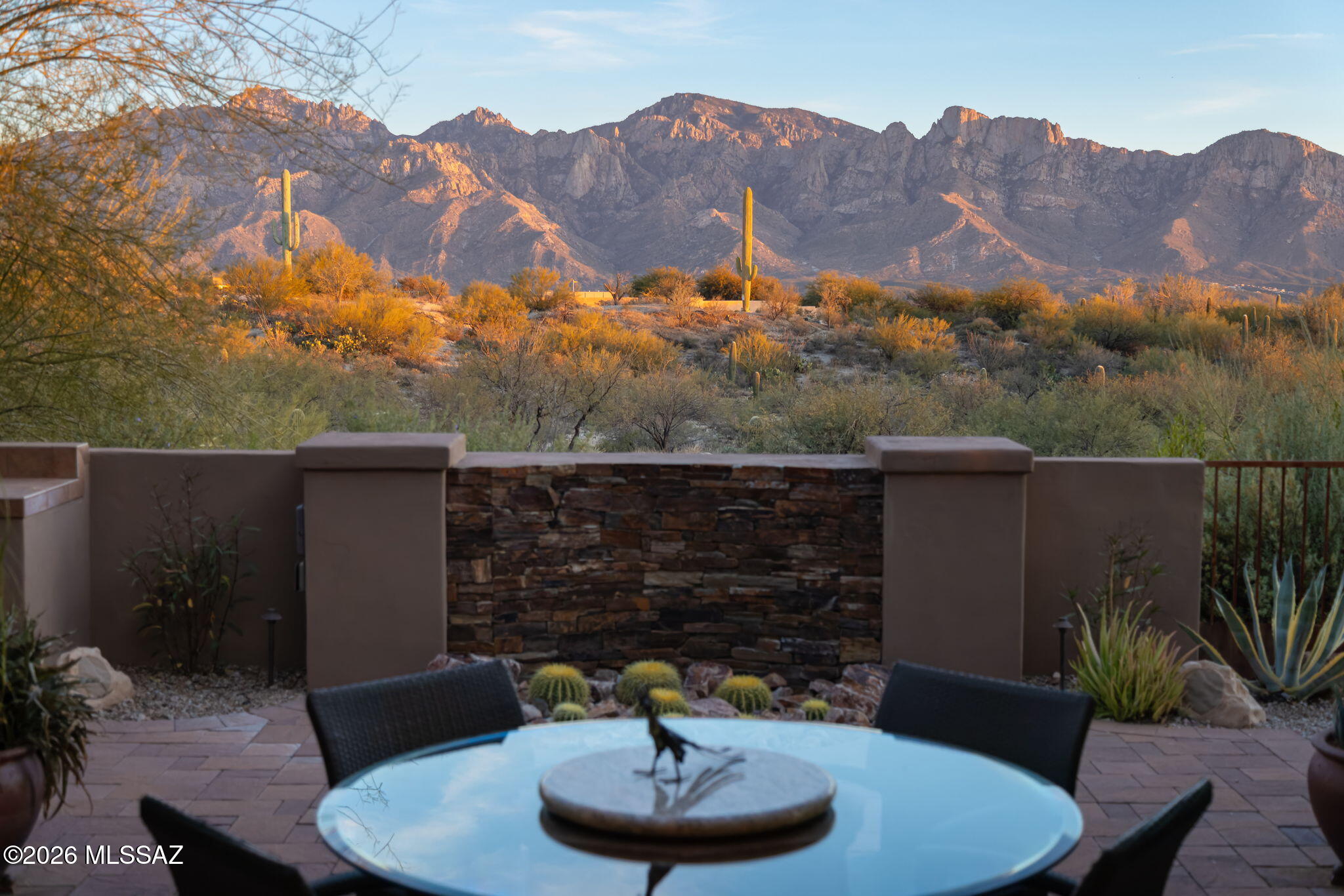 Wow! Panoramic Catalina Mountains & Tucson city lights views in prestigious guard-gated Stone Canyon golf community! Gorgeous 3360SF open design with lots of light, luxury amenities, split layout, 3 generous suites, powder room, & den/office/game room. Living area stone fireplace & TV wall surrounded by high windows has access to 2 patios with stunning views, firepit & BBQ. Spacious dining area is next to walk-in wetbar & amazing kitchen with entertainment-sized island, soft-close cabinetry, built-in appls including 36'' gas cooktop with professional hood. Master suite includes patio access, large spa-like bath with tub & walk-in shower, huge closet with direct access to laundry. Deep 3-car tandem garage. Elevated cul-de-sac location provides privacy & awesome views. Club Membership req'd