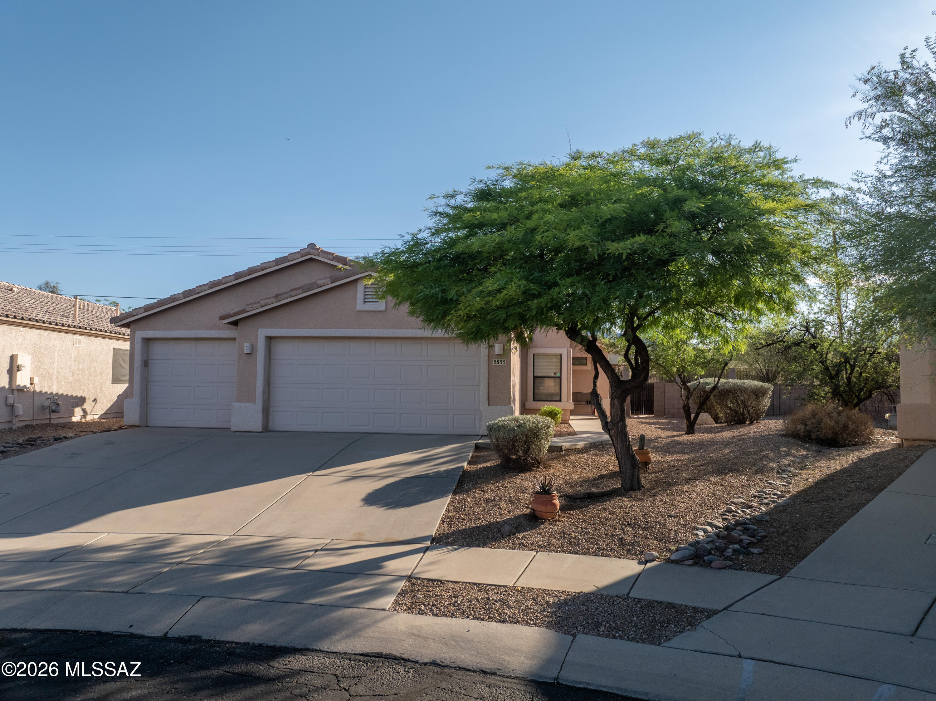 Come see this beautiful, move-in-ready home! Inside, enjoy fresh paint, upgraded flooring, vaulted ceilings, a new tile fireplace, and a split floor plan with an updated, modern primary suite. The spacious three-car garage also includes a dedicated workspace or storage room.

Outside, the oversized lot backs onto a natural buffer zone, perfectly blending desert serenity with gated community security. This certified National Wildlife Federation neighborhood features scenic trails, and the year-round heated community pool and playground are just a 5-minute walk away. Plus, you are ideally located just minutes from local shopping and I-10 for an easy commute.  Schedule an appointment to see this beautiful home!
