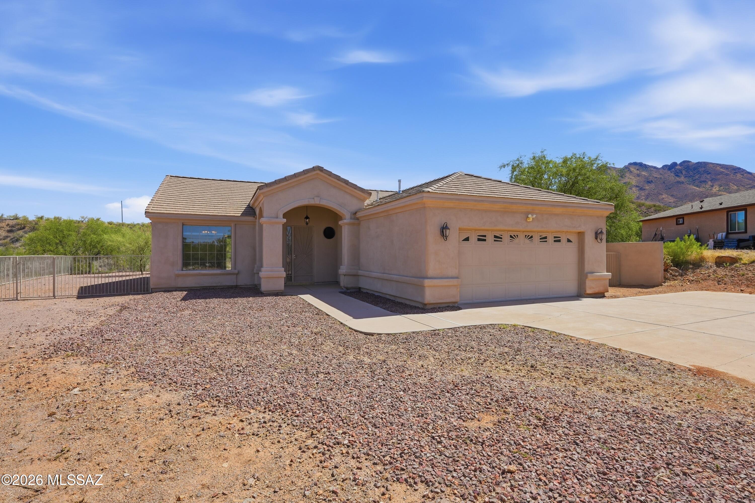 Enjoy beautiful mountain views and AZ sunsets from the living room, breakfast nook, family room, and covered rear patio in this well-maintained 1,834 sq. ft. home on .58 acres. Built in 2007, this split-bedroom floor plan offers 3 bedrooms, 2 full baths, an open living area, ceramic tile flooring throughout, granite countertops in the kitchen and baths, kitchen pantry and cabinets with pull-out shelves, breakfast nook, and laundry room with utility sink. Tile roof, enclosed backyard with room for an RV, trailer, or recreational toys, and no HOA. Conveniently located in Ranchettes Unit 17 with quick access to I-19 via Palo Parado Road for commuters. Includes the remaining 6 months of an AHS Home Warranty for added peace of mind. This home is perfect for families who love to entertain with spacious living areas, fenced yard, large covered patio, and beautiful Arizona sunsets! A perfect home for comfortable living.