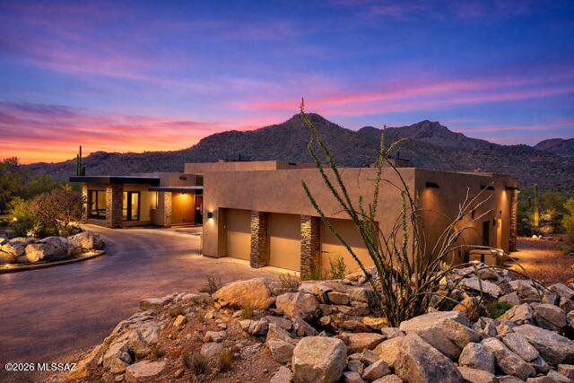 Experience elevated desert living in the exclusive guard-gated community of Saguaro Ranch, nestled within the breathtaking Tortolita Mountains of Arizona. Scheduled for completion in June, this exceptional new construction residence combines timeless architecture with refined modern luxury. Thoughtfully designed by Greg Simmons Home Design and masterfully built by Michelle Palafox of Macoyosh Builders, Old Ranch House #8 rests on a private 4.14-acre homesite surrounded by sweeping desert vistas. 

Crafted with both sophistication and comfort in mind, the split floor plan offers two generously sized en-suite bedrooms, a private library, and an expansive three-car garage. Inside, curated designer finishes and impeccable craftsmanship define every space. The chef's kitchen is appointed with premium Wolf and Sub-Zero stainless steel appliances, while the dramatic living area showcases a striking fireplace clad in Interno Bronze tile imported from Italy.

The luxurious primary suite serves as a private retreat, highlighted by exquisite Magnifico Nero tile and a spa-inspired bath featuring Invictus Pearl Cut and Invictus Ivory Vein tile selections that evoke a true resort experience.

Seamless indoor-outdoor living is at the heart of the home, with expansive entertaining spaces opening to a resort-style pool and outdoor kitchen set against a spectacular desert backdrop.

Ideally located near Tucson's premier golf destinations, including The Golf Club at Dove Mountain, The Highlands at Dove Mountain, and The Gallery Golf Club, this extraordinary property also offers optional access to the exclusive Saguaro Ranch Clubhouse amenities, featuring a lap pool, bocce ball, pickleball courts, and a fitness center.