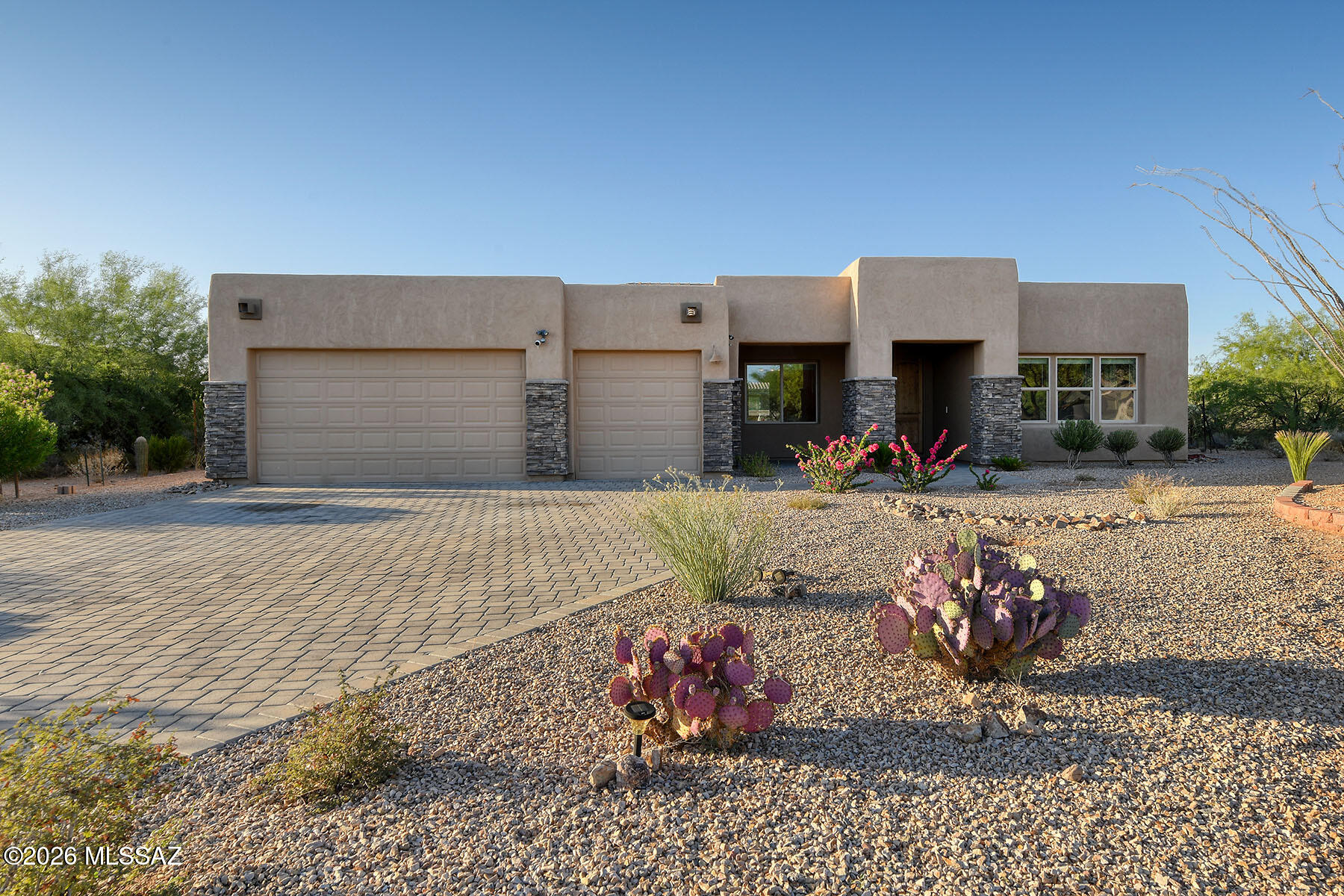 Nestled behind the prestigious gates of Stone House in Sahuarita, Arizona, this stunning family home offers an unmatched combination of elegance, comfort, and Arizona living at its finest.
The curb appeal is simply breathtaking. A sweeping paver driveway leads you to a beautifully appointed façade adorned with stone accents that frame the entrance with timeless sophistication. Every detail of the exterior has been thoughtfully designed to make a lasting first impression. Step inside and be immediately captivated by the magnificent great room -- the true heart of this home. Soaring windows line the entire back wall, flooding the space with warm, natural light and framing picture-perfect views of the private backyard. Whether you're entertaining guests or enjoying a quiet evening with fami the seamless connection between indoor elegance and outdoor beauty makes every moment feel extraordinary.
The open-concept kitchen is a dream for any home chef or host. Gleaming finishes, ample counter space, and a generous center island make meal preparation a pleasure, while the layout keeps you connected to everything happening throughout the home. Pull up a stool at the bar seating for casual conversation, gather in the sun-drenched breakfast room for lazy weekend mornings, or set the scene in the separate formal dining area for the celebratory family dinners and special occasions that create lasting memories.
The thoughtful split floor plan offers something every family treasures -- privacy. Three additional bedrooms are tucked away on the opposite side of the home, creating an ideal retreat for teenagers, guests, or a dedicated home office, while the owners are afforded their own peaceful sanctuary. The luxurious owner's suite is a true escape, featuring a deep soaking tub, a walk-in shower, and a door that open directly onto the covered patio -- your personal invitation to enjoy the outdoors any time of day.
Speaking of outdoors, the covered patio is made for Arizona evenings. Dine al fresco under the stars, sip your morning coffee as the sun rises, or simply unwind in the fresh desert air. And the generously sized backyard? It's a blank canvas ready to reflect your lifestyle. Dream of a sparkling swimming pool? A play area for the kids? A custom putting green? The space is here -- bring your vision and make it your own.
Priced competitively to allow the new owners the opportunity to put their personal stamp on the outdoor space, this home represents outstanding value in one of Sahuarita's most sought-after communities. The bones are exceptional, the interior is move-in ready, and the backyard is simply waiting for your imagination. Opportunities like this in Stone House don't last -- schedule your private showing today!
