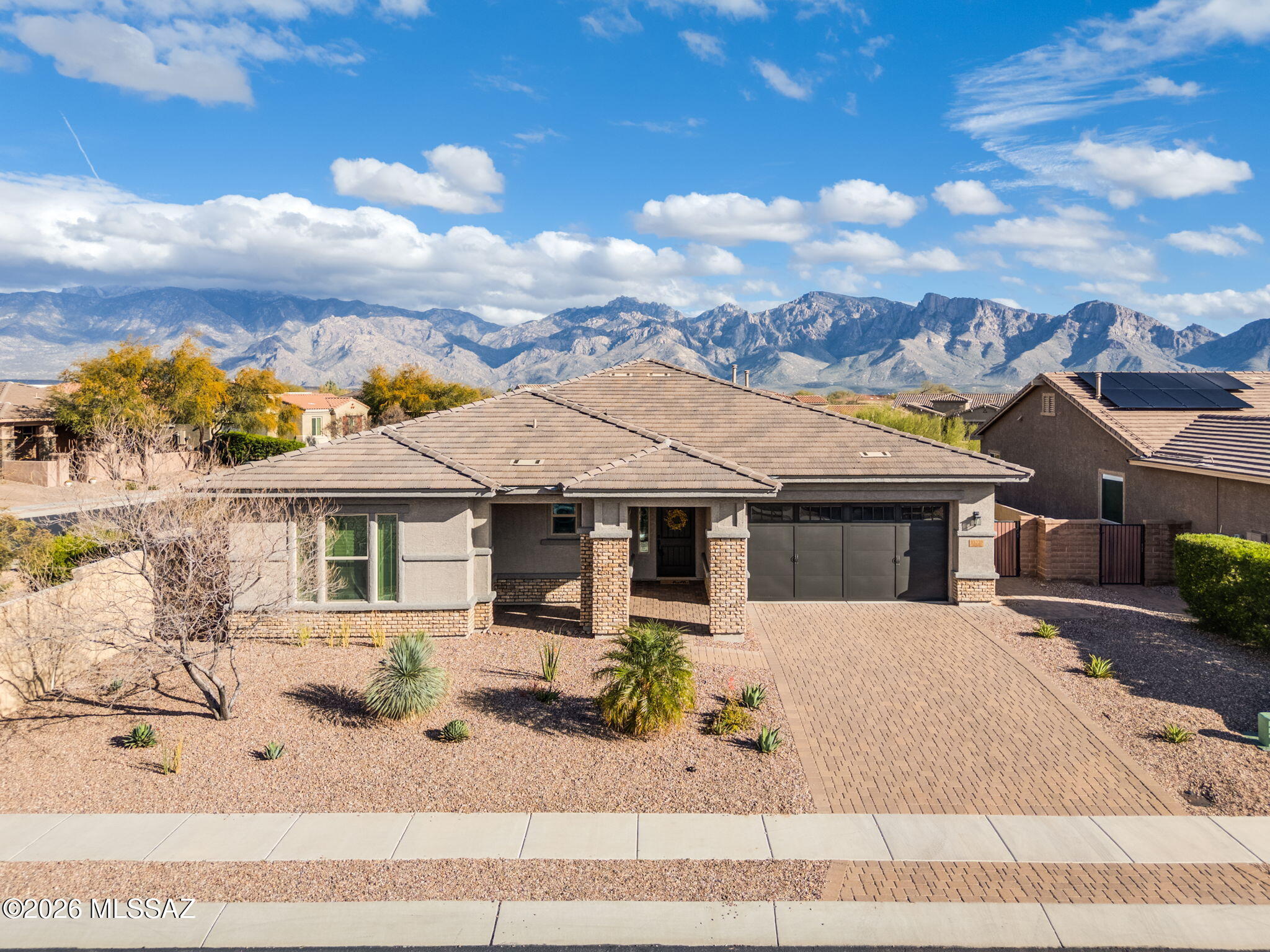 Welcome to this exceptional residence in the gated community of Center Pointe Vistoso, nestled in the heart of Oro Valley. Offering 3,194 sqft of thoughtfully designed living space, this stunning 4BD, 3.5BA home with a den and bonus room seamlessly blends elegance, comfort, and modern functionality. Step through the entry and immediately experience the remarkable finishes and open-concept floor plan that create a seamless flow throughout the home. Designer touches, upgraded fixtures, and quality craftsmanship are evident at every turn. The expansive layout leads you into a true chef's kitchen featuring state-of-the-art appliances, quartz countertops, upgraded cabinetry,butler's and a spacious walk-in pantry perfectly designed for both everyday living and entertaining. The oversized island offers generous prep space and additional seating, making it the natural gathering place for family and friends. The spacious great room is a true centerpiece, showcasing a full wall of custom built-ins that add both sophistication and practical storage. The seamless connection between the great room, kitchen, and dining area enhances the home's open and airy feel. The luxurious owner's suite is thoughtfully positioned within the split floor plan for maximum privacy. This serene retreat features a spa-inspired bath complete with dual vanities, quartz countertops, soaking tub, an oversized walk-in shower, and an impressive walk-in closet. It's the perfect escape at the end of the day. On the opposite wing of the home, you'll find three generously sized guest bedrooms and two full bathrooms, offering comfort and convenience for family or visitors. A versatile bonus area provides endless possibilities playroom, home gym, media room, or teen retreat while the dedicated den makes an ideal home office, study, or flex space. Retreat outdoors to your beautifully designed backyard featuring an extended paver patio and built-in BBQ perfect for year-round entertaining. Several mature citrus trees enhance the space, offering both charm and fresh seasonal fruit. Capture breathtaking sunrise and sunset views while enjoying Arizona's stunning desert skies. This home has been meticulously maintained and thoughtfully updated. A new HVAC system installed in 2026 includes a 10-year transferable warranty for added peace of mind. The exterior has been completely repainted, and numerous additional improvements have been completed (see detailed list under documents). Ideally located just a short walk from the community pool, spa, park, splash pad, and recreation center, this home offers not only luxury and privacy, but also convenient access to exceptional amenities.