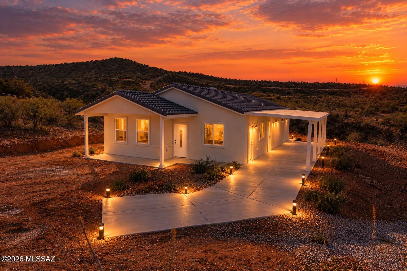 Welcome to a home that feels as good as it looks. Nestled in the heart of Rio Rico's stunning desert landscape, this charms-filled 3-bedrooms, 2 bathrooms retreat sits on over an acre of pristine land. From the moment you walk in, the spacious, sun-drenched living area makes you feel right at home. The heart of the house-the kitchen -boasts beautiful alder wood cabinets and durable quartz counters. Outside the elevated ''perch'' of the lot offers a peaceful sanctuary where you can start your mornings and end your nights watching the colors change over the San Cayetano Mountains.