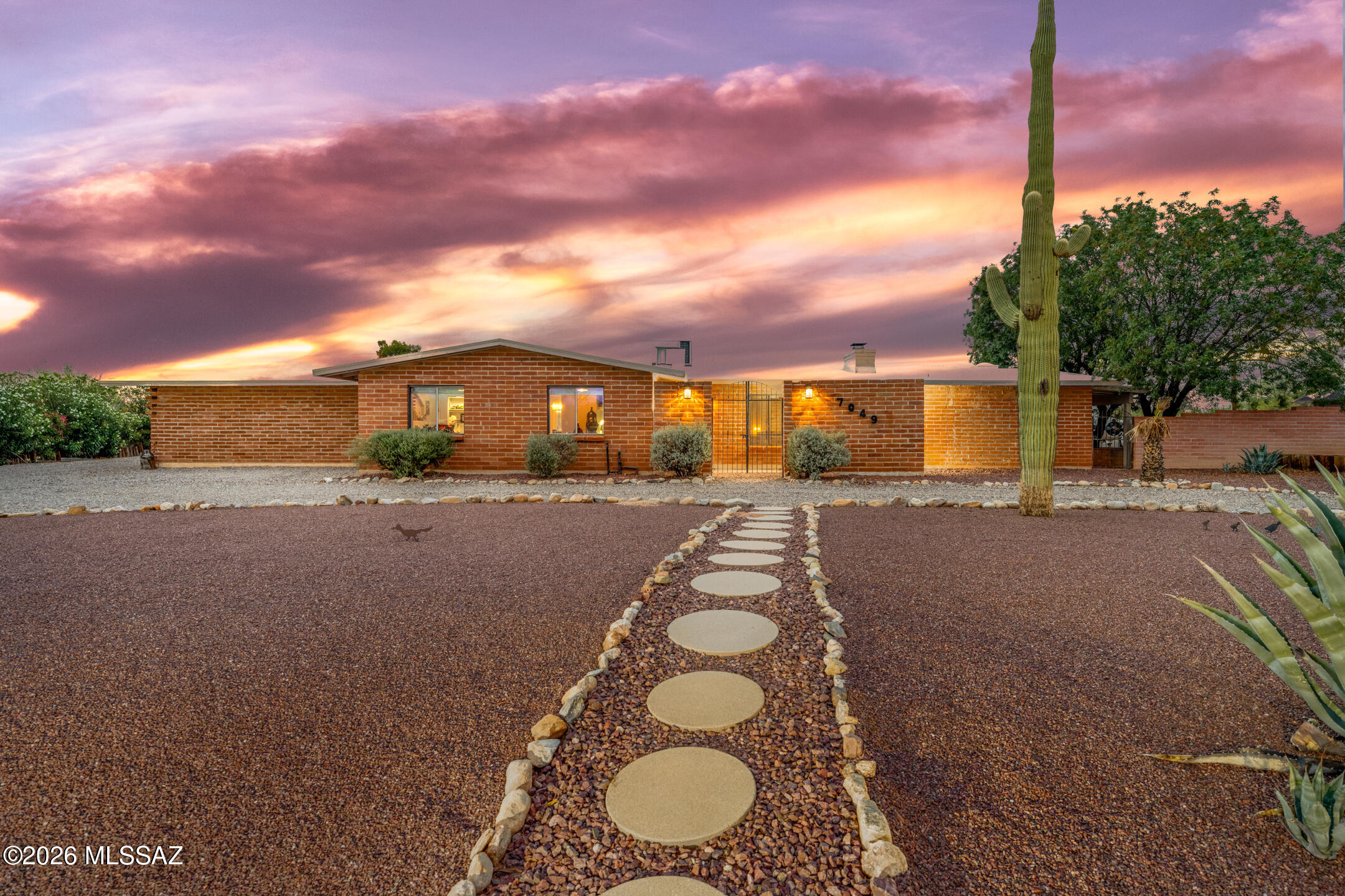 Tucked away on nearly an acre in sought-after Oracle Heights Estates, this beautifully updated burnt adobe ranch offers the space, flexibility, and character that are becoming increasingly difficult to find. From the moment you arrive, the circular drive, mature desert landscape, and timeless architecture create a sense of privacy and permanence. Inside, over 3,300 square feet of thoughtfully designed living space unfolds with expansive gathering areas, a formal dining room, an oversized chef-inspired kitchen, and multiple spaces to live, work, entertain, and unwind. The heart of the home is a stunning kitchen featuring quartz countertops, extensive cabinetry, prep sink, gas cooking, and a large center island designed for everything from busy mornings to holiday gatherings. Continued... Two fireplaces, skylights, built-in features, and mountain views add warmth and character throughout.

The primary suite is truly exceptional--offering the size and versatility rarely found in today's homes. With room for a sitting area, home office, fitness space, or private retreat, it feels like an entire wing dedicated to comfort and relaxation.

One of the home's standout features is its oversized flex room complete with an adjacent full bath. Need a fifth bedroom? Home gym? Media room? Hobby studio? Teen retreat? Guest quarters? Home office? This versatile space offers the freedom to create the lifestyle you've always wanted without compromising the functionality of the rest of the home.

Step outside to enjoy covered patios, low-maintenance grounds, and room to create the backyard you've always envisioned. For hobbyists, collectors, entrepreneurs, or outdoor enthusiasts, the detached garage/workshop and extensive storage space provide endless possibilities. RV parking, an RV gate, and covered parking complete the package.

Located in the heart of Tucson's desirable Northwest side, this property combines privacy, convenience, and versatility in a way few homes can.

Your next chapter starts here.