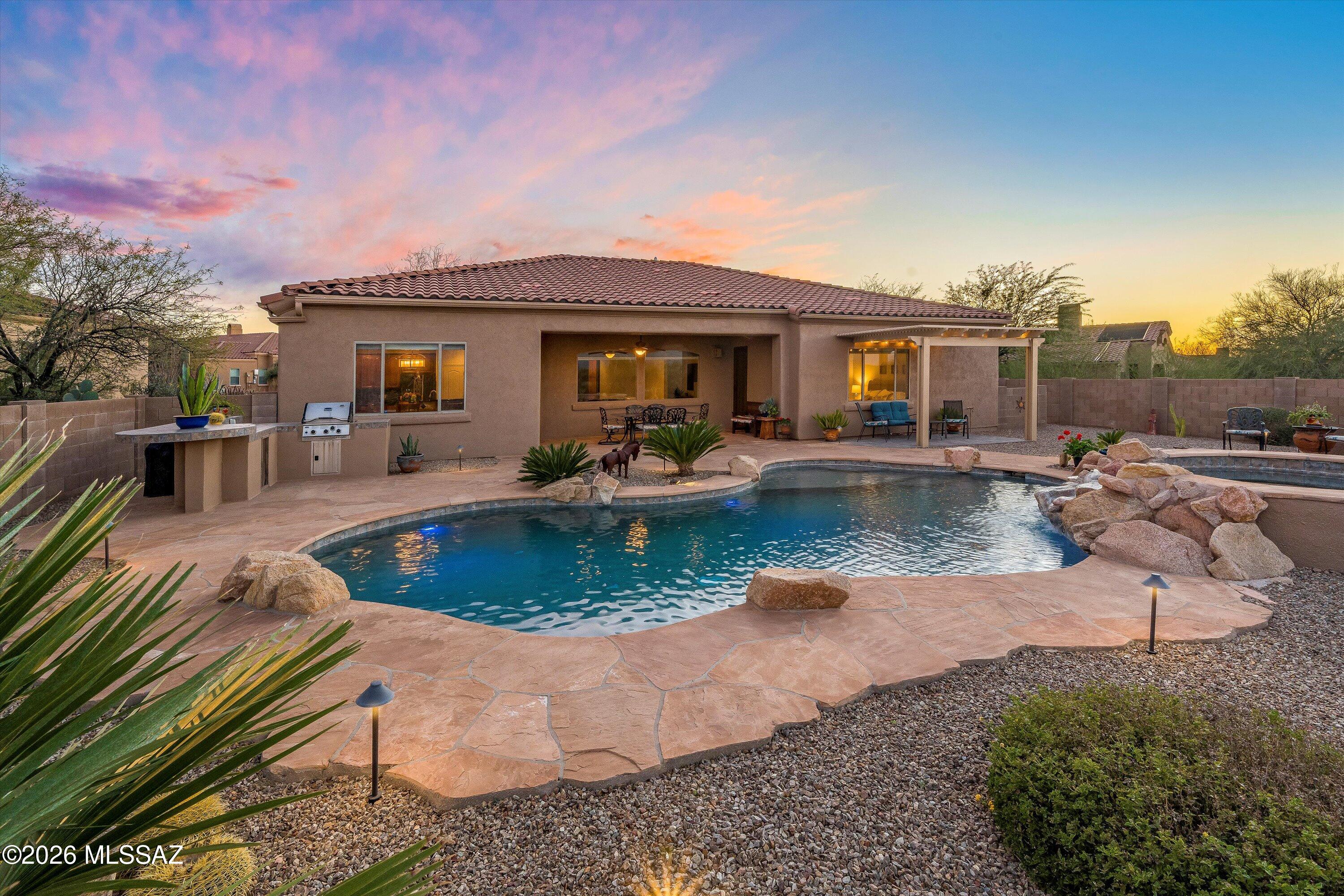Experience refined desert living in this beautifully maintained home featuring spacious living areas with timeless travertine flooring. The standout backyard is designed for both relaxation and entertaining, complete with a solar-heated pool, spa, a horseshoe pit and expansive patio space perfect for enjoying Arizona's stunning weather.
Backing to state land, the property offers added privacy along with breathtaking mountain views and unforgettable sunsets. The seamless blend of indoor comfort and outdoor beauty creates an inviting atmosphere ideal for everyday living or hosting guests. Conveniently located near local amenities and within the award winning Vail School District, this home provides a peaceful desert setting for the lifestyle many are seeking.