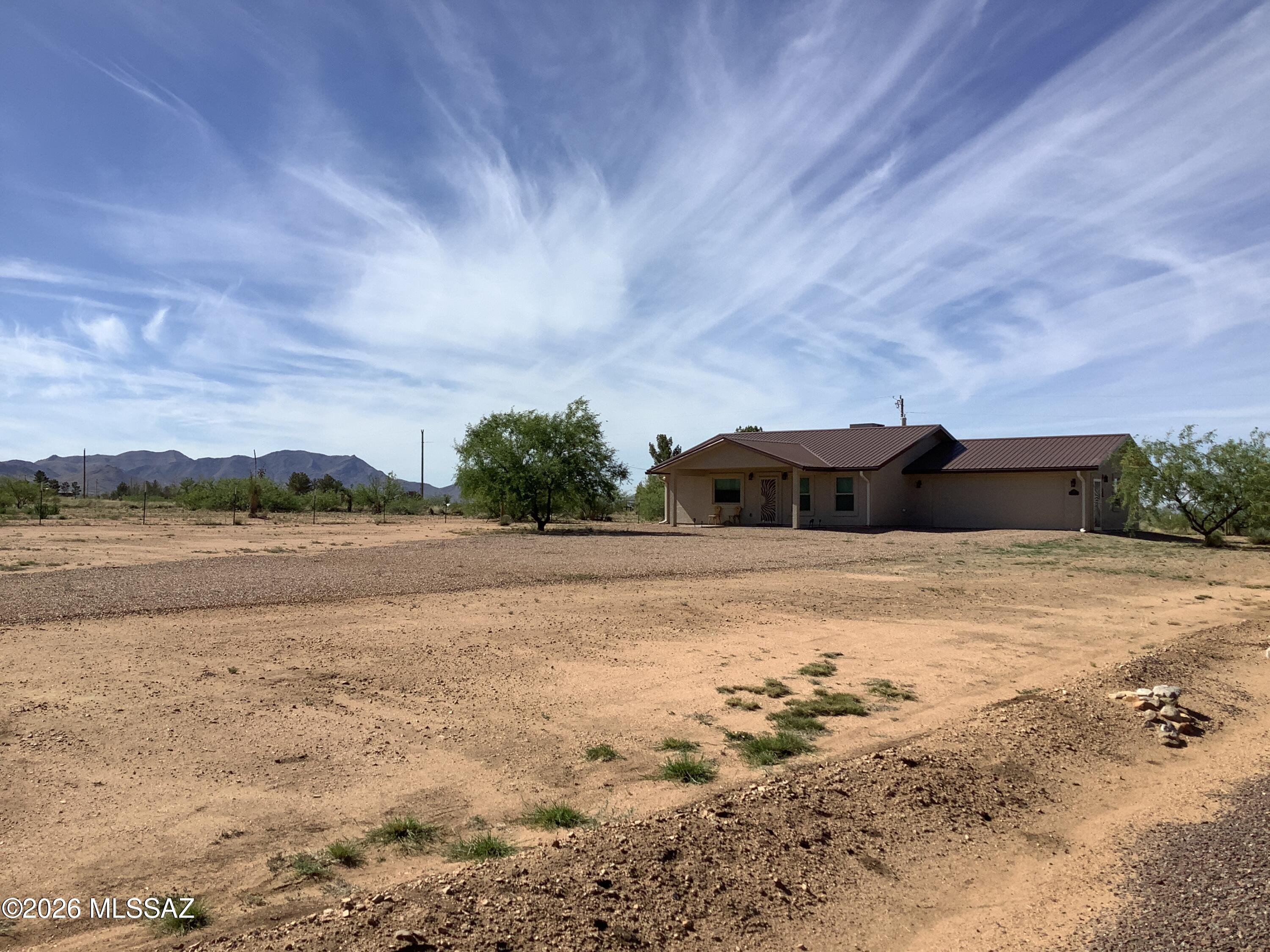 This 2023 custom built two-bedroom, two-bathroom home was designed for easy living. Spacious living room with pellet stove, double pane energy efficient window to look at the unobstructed views of the Cochise Stronghold.  Eat-in-kitchen with breakfast bar that has granite countertops, alder pine cabinets and SS appliances. The primary bedroom has lots of storage and handicapped no curb walk in shower. Nice sized laundry room and two-car attached garage.  Property fenced and a gate at the driveway.  The home still has builder warranties along with five-year termite warranty. This home is close to the Sunsites Community with all its amenities to use. If you are looking for a peaceful relaxing home, you do not have to look any further, come and see what this home has to offer.