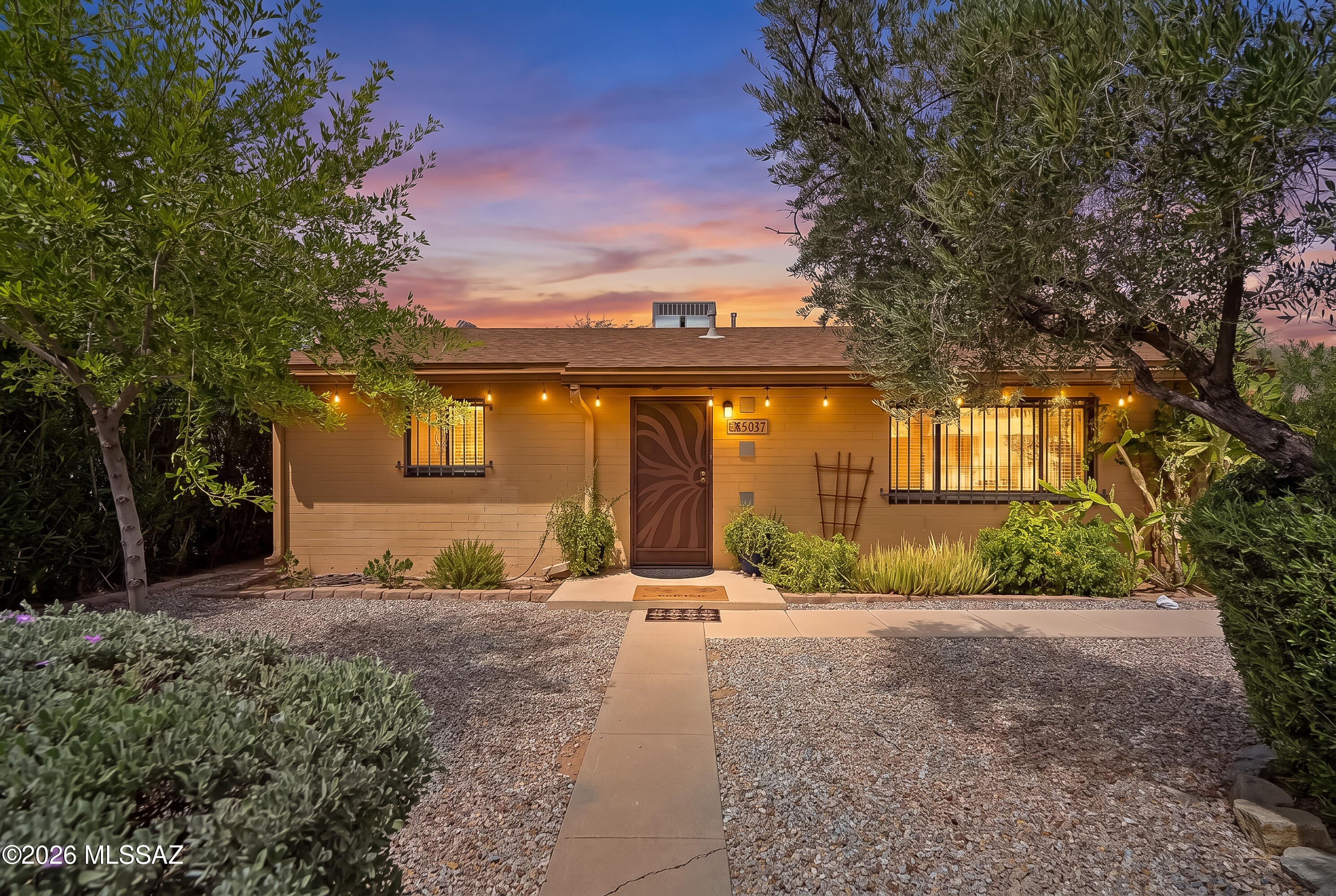 Fall in love with this charming 1950s brick gem, updated and ready to welcome you home! New roof coming! The remodeled kitchen with newer stainless steel appliances, granite counters, a tile backsplash, and updated cabinets. Sunlight pours through dual-pane windows onto neutral tile and warm wood laminate flooring. Relax with peace of mind thanks to security doors/windows, ceiling fans, and solid block construction with a newer HVAC. Step outside to your own private oasis -- a huge, fully enclosed rear yard with a covered patio and double gated entry, perfect for pets and entertaining. Attractive steel front fencing, rain gutters, and no HOA add to the appeal. Near TMC and St Joseph hospital and Rincon HS. Furnishings available on a separate bill of sale. Updated and waiting for you