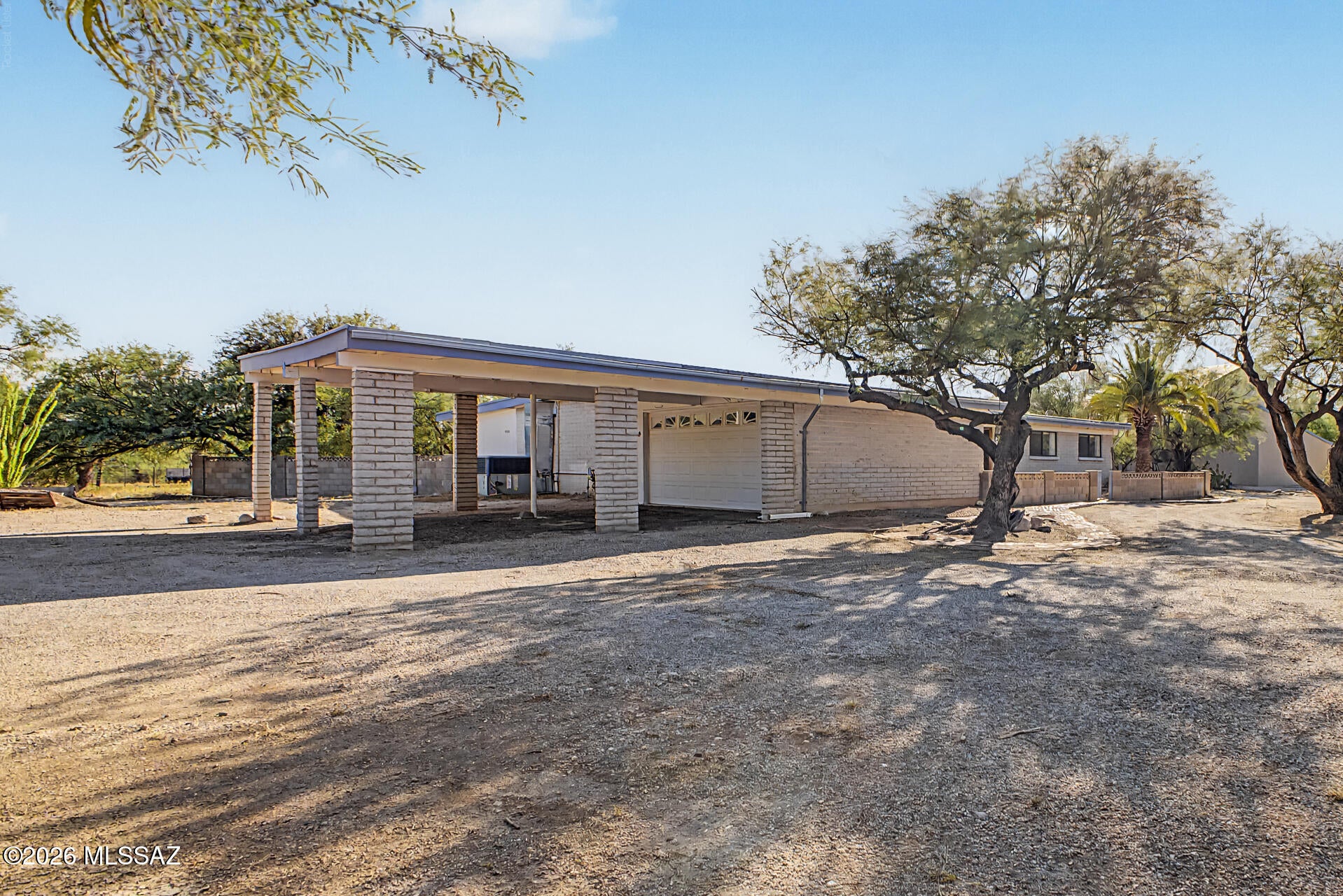 Enjoy peaceful desert living on a full 1-acre property on Tucson's desirable northeast side! This spacious 4-bedroom, 2-bath home offers 2,375 sq ft, a sparkling pool, RV pad with electric and water hookups, and a powered barn/shed for storage, hobbies, or a workshop. A circular drive leads to a private courtyard with charming stained-glass accents. Inside, natural light, beautiful wood doors and trim, a large kitchen island, and an oversized laundry room add warmth and functionality. Relax under the expansive covered patio while enjoying the surrounding Sonoran Desert and mountain scenery. Conveniently located near Mount Lemmon, shopping, dining, golf, parks, and horseback riding.