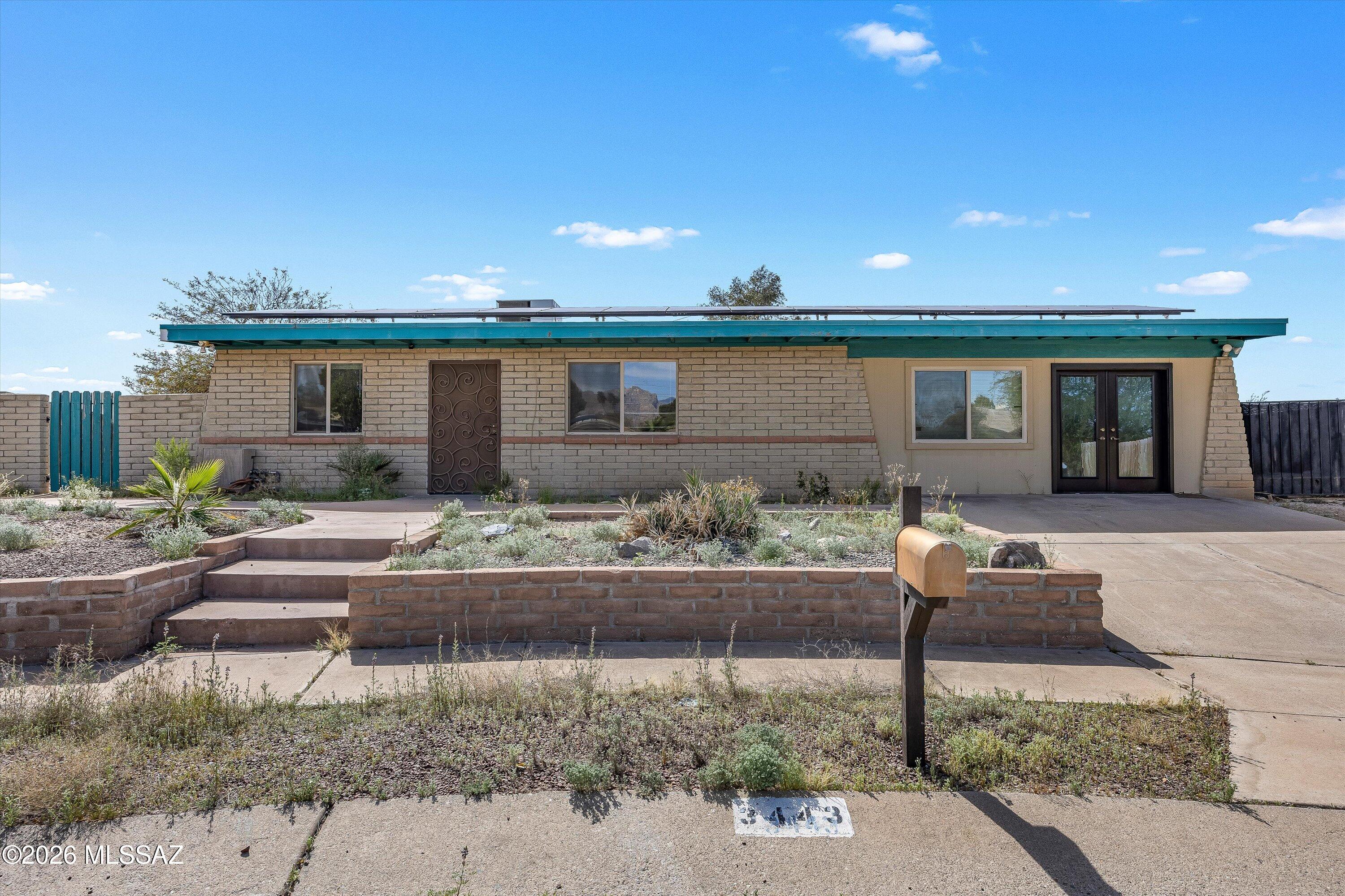 Investor special! All offers will be reviewed on March 22. Great opportunity to fix up this former model home on a quarter acre. Located on a cul-de-sac with panoramic mountain and sunset views from the backyard. This 4 bedroom 2 full bath home with a great room and separate family room is full of potential. Solar will be paid off at closing. Only .3 mi or 5 minute walk to The Loop, Tucson's shared-use path that totals 120 miles! Close to Costco, shopping, dining, schools, parks, and more.