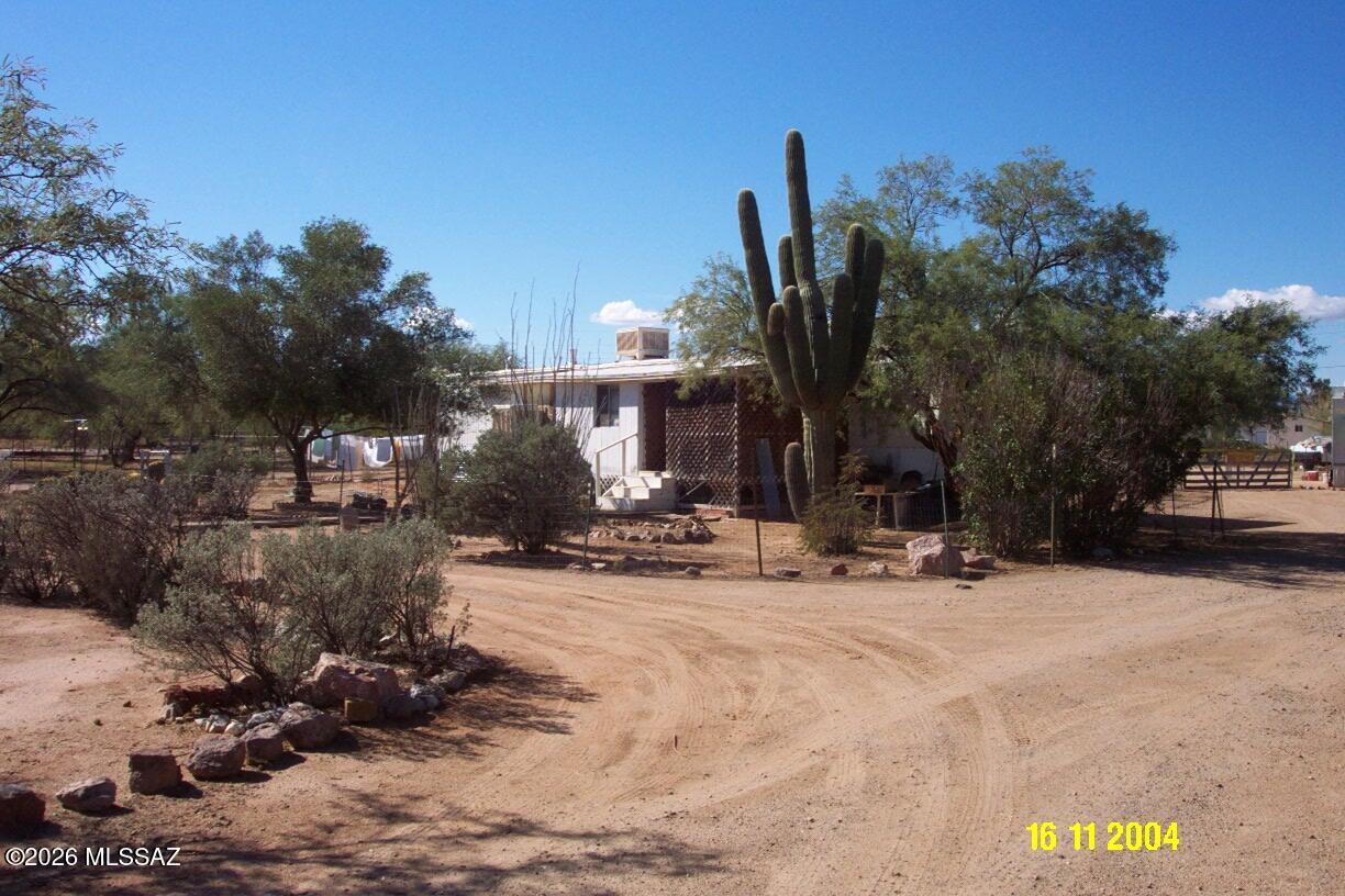 Investors take a look. SH zoning allows for more than one home. There were 2 homes originally, but only the single wide 2 bdrm 1 bath MH with
an addition and the small guest house exists. There were 2 elec meters, 1 is turned on. Seller selling As Is and will do no repairs. This is a great lot as a remodel or start from scratch by adding your own home. NO HOA so bring your toys and imagination!