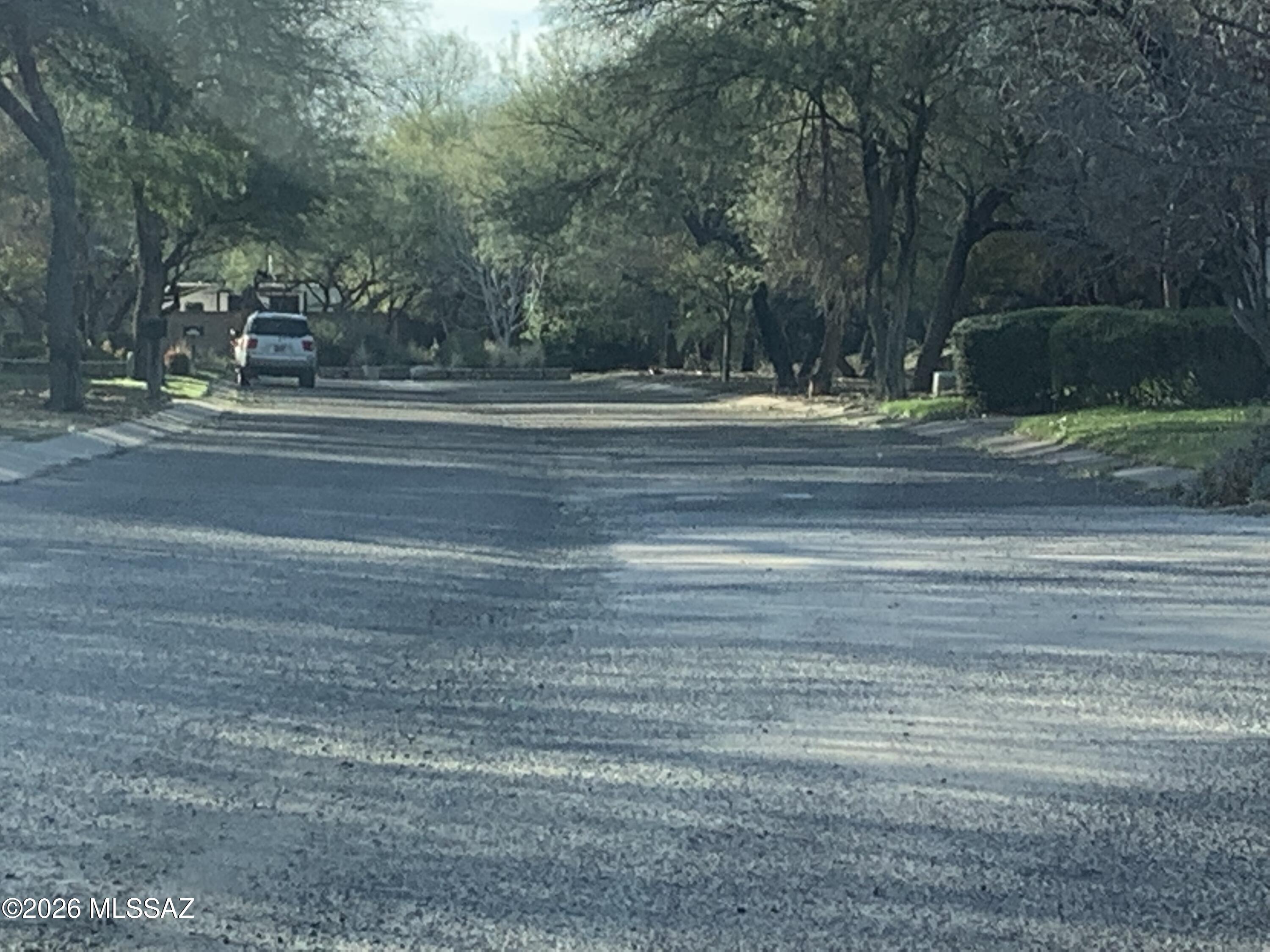 This one third of an acre lot is nestled in a forest of large mesquite trees. It was created back in 1998 thru a City of Tucson rezoning. The uniqueness of the property is preserved thru the native plant preservation plan, design guidelines and CC&R's. The two newer homes suggest a community value for a new home of $800k. This is your opportunity to work with a custom builder and/or architect to create a home reflecting all of innovations and design features currently being used in 2026. The location is just minutes from shopping, Udall Park and boarders the Rillito loop bike trail.