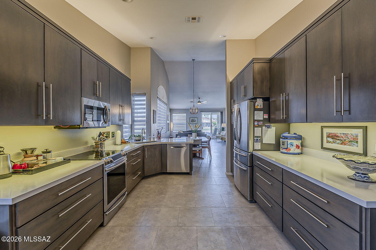 Enjoy refined, low-maintenance living in this beautifully updated SaddleBrooke One Portofino villa, a short stroll from the clubhouse and resort-style amenities. This inviting 2-bed, 2-bath retreat features updated tile flooring, taupe cabinetry w/pull-outs, quartz countertops, and cozy gas fireplace. The charming kitchen nook is perfect for morning coffee, reading, or a quiet workspace. Spacious primary suite offers a zero-grade walk-in shower for effortless comfort. Relax on the NE facing patio overlooking the golf course, from the private wide lot. Hunter Douglas Silhouette shades, stylish ceiling fans, and extra storage add thoughtful touches. With the HOA maintaining the roof, exterior paint, and landscaping, you'll have more time to savor the SaddleBrooke lifestyle.