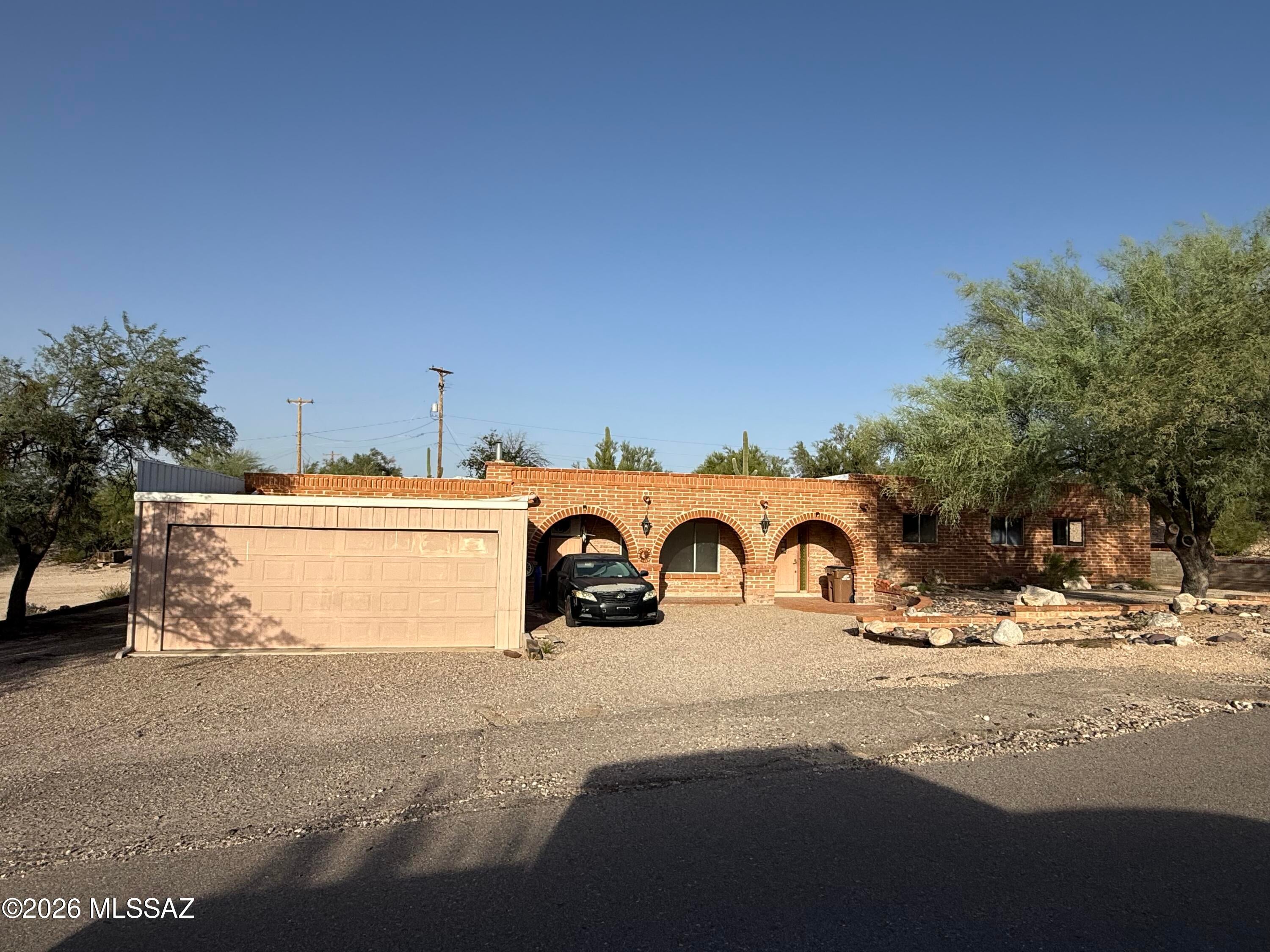 Bring your vision to life with this spacious 2,482 sq. ft. Adobe home on a generous .83-acre lot in desirable NW Tucson near La Canada & River Road. This property offers a blank canvas with endless potential to create your dream home. Renovations have begun, including popcorn ceiling & carpet removal. Large master bedrm w/ his & her closets. Double vanity sinks with lots of counter top in Master bath. A standout feature is the incredible garage space, with a 4-car garage in front and an additional 6-car garage in back--perfect for car collectors, hobbyists, workshops, or a home-based business. The home's lot leaves plenty of room to build a guest house. Conveniently located near shopping, dining, and everyday amenities, this unique property offers space, flexibility, and opportunit