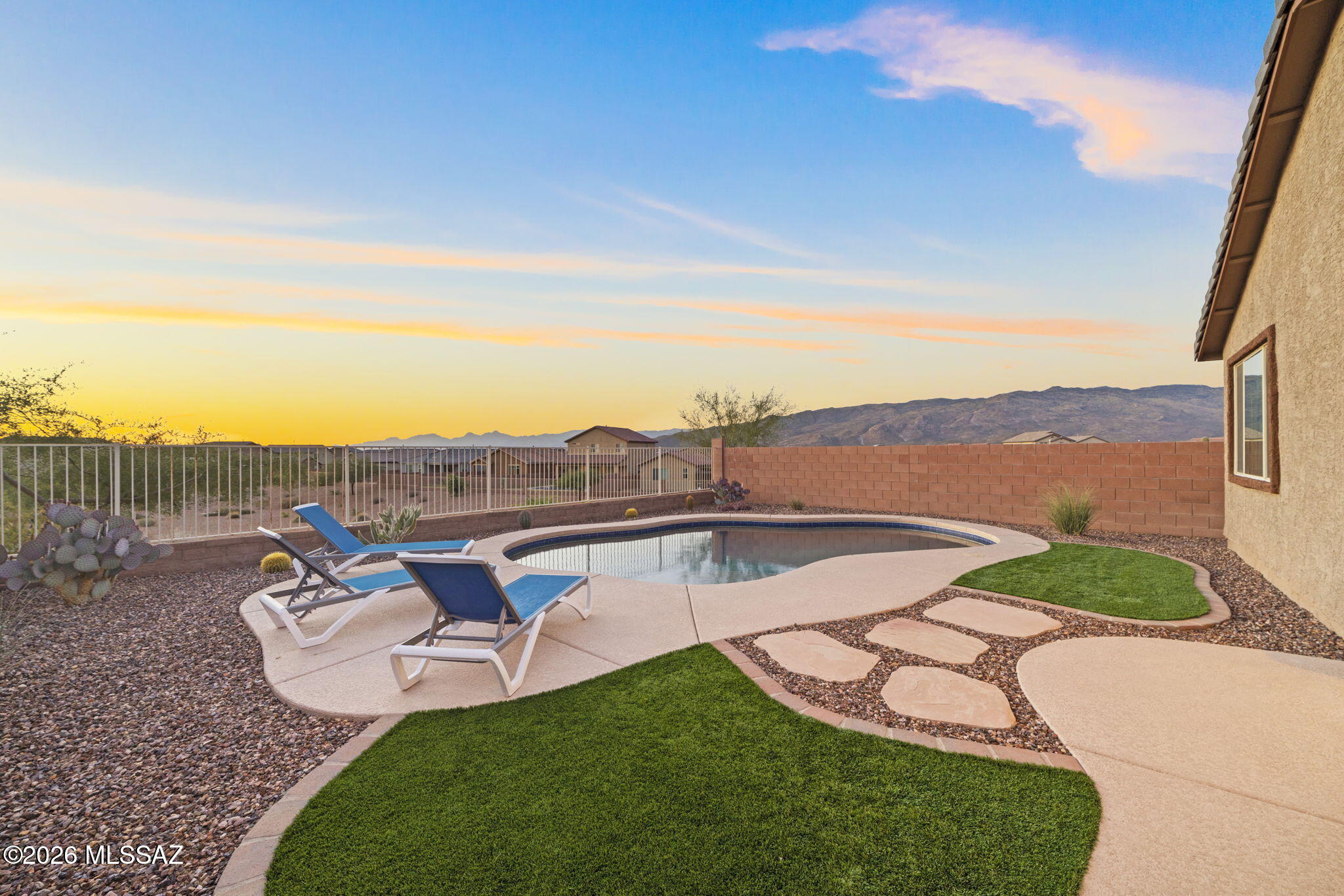 Discover modern desert living in this beautifully upgraded 3 bed, 2 bath home located on a premium corner lot in the sought after Rocking K community. This single story layout features an open concept great room, a clean white cabinet kitchen with stainless steel appliances, granite countertops, & wood look tile throughout with plush carpet in the bedrooms for added comfort.
Step outside to your private backyard retreat with a sparkling pool, no rear neighbors, & peaceful unobstructed mountain views. The spacious 3 car tandem garage offers extra storage or workshop flexibility. Situated next to a quiet cul de sac, this home provides added privacy while still being close to parks, trails, award winning Vail Schools, & Rocking K amenities. A perfect blend of style, comfort, & location.