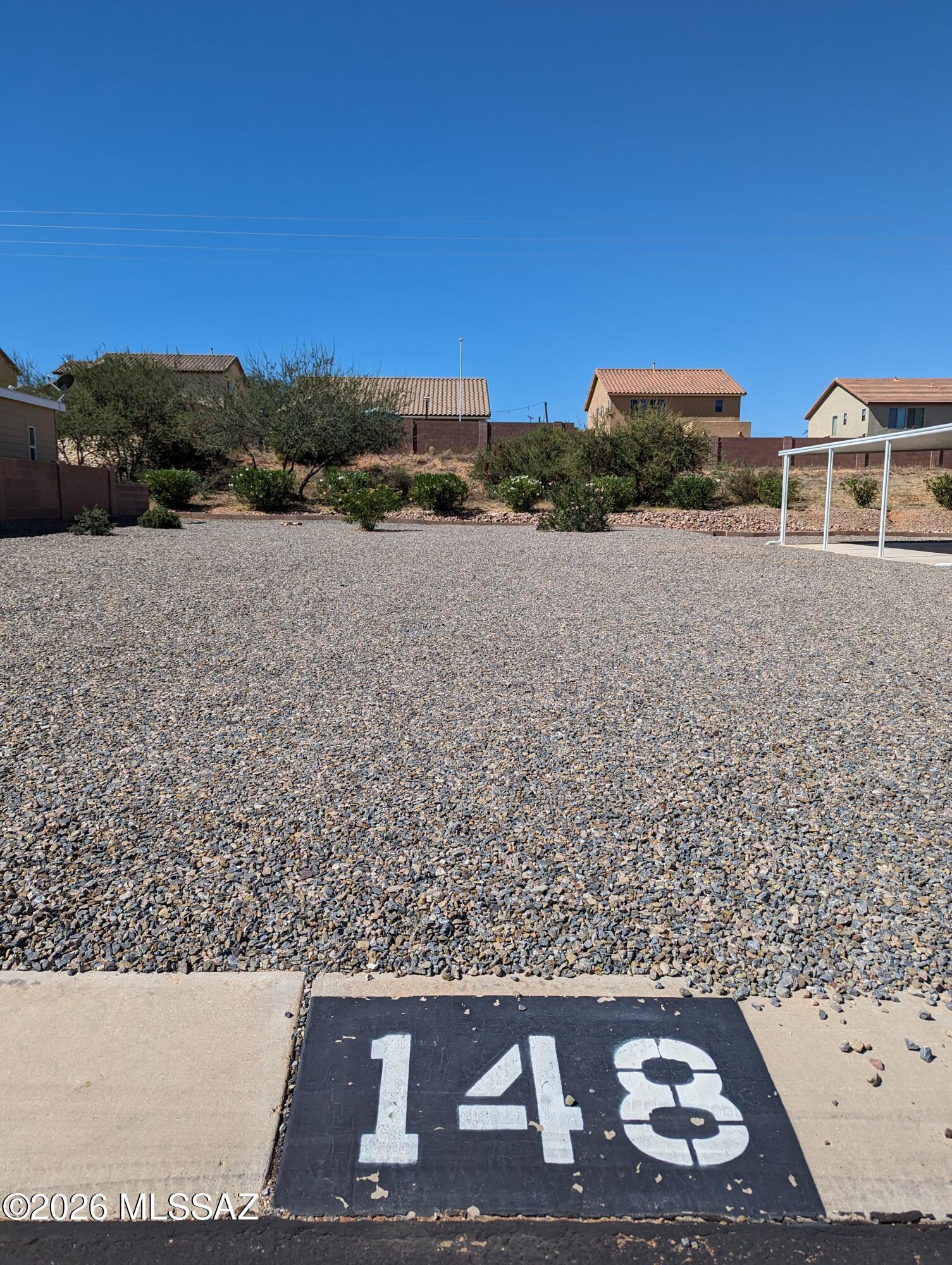 Nice flat lot on a paved street in a gated community. Situated right in between Sierra Vista and Tucson. Water, gas, electric, phone and internet at the lot line! There are restrictions on the size of the house you put on this lot, call listing agent for details. 
Great opportunity to part time in Benson or live here full time. Nice