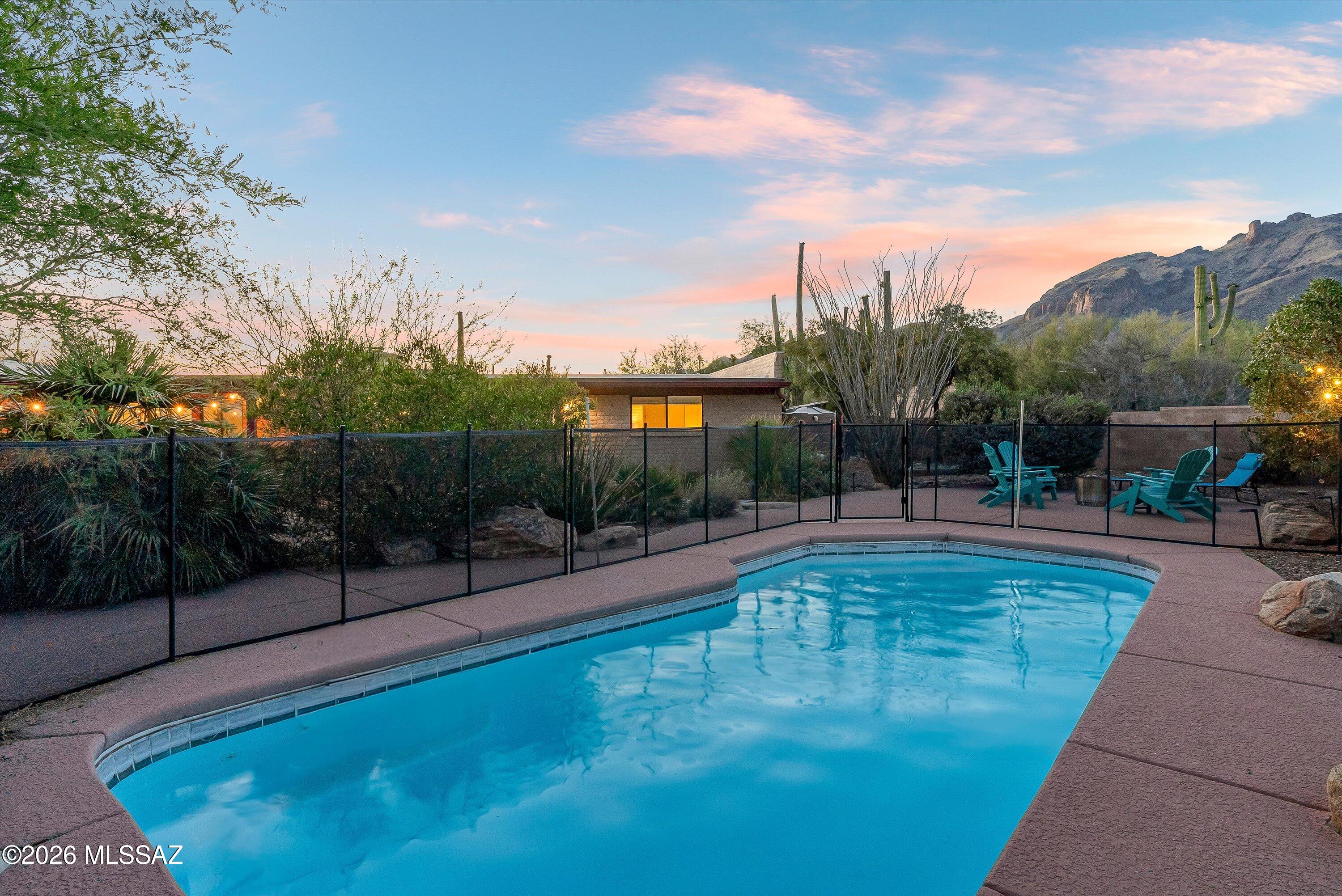 Experience the beauty of the Catalina Foothills from this thoughtfully maintained home featuring breathtaking mountain views, smart home upgrades, and a professionally designed resort-style backyard. Situated near the base of Finger Rock Trail, this property offers a peaceful desert setting while remaining close to premier shopping, dining, recreation, and highly sought-after schools. Additional highlights include a new 2025 foam roof that has already contributed to reduced electricity costs, a smart thermostat, WiFi-enabled garage door control, a fully enclosed yard with two gated entries, and a larger-than-average lot for the neighborhood. Thoughtful desert-friendly features include an easy-maintenance front yard, WiFi-enabled drip irrigation system, and a rainwater collection system with two barrels. A newly installed WiFi-enabled pool pump and smart home features throughout add convenience, especially for seasonal residents or those who travel frequently.
Inside, the home offers a bright and spacious floor plan filled with natural light. The open living areas create a comfortable flow for everyday living and gatherings, while the kitchen provides ample space for cooking and entertaining. The primary suite features a private ensuite bathroom, while two additional bedrooms and a spacious guest bathroom offer flexibility for family, guests, or a home office. Blackout curtains in all three bedrooms provide added comfort and privacy.
Conveniently located near Catalina State Park, La Encantada, and downtown Tucson, this Foothills property combines scenic desert living with modern convenience and easy access to some of Tucson's most desirable amenities. Backing to preserved community-owned land that cannot be developed, the home enjoys an added sense of privacy.